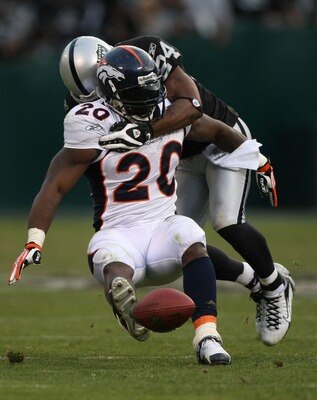 OAKLAND, CA - DECEMBER 2:  Travis Henry #20 of the Denver Broncos is tackled by Michael Huff #24 of the Oakland Raiders during an NFL game December 2, 2007 at McAfee Coliseum in Oakland, California.  (Photo by Jed Jacobsohn/Getty Images)