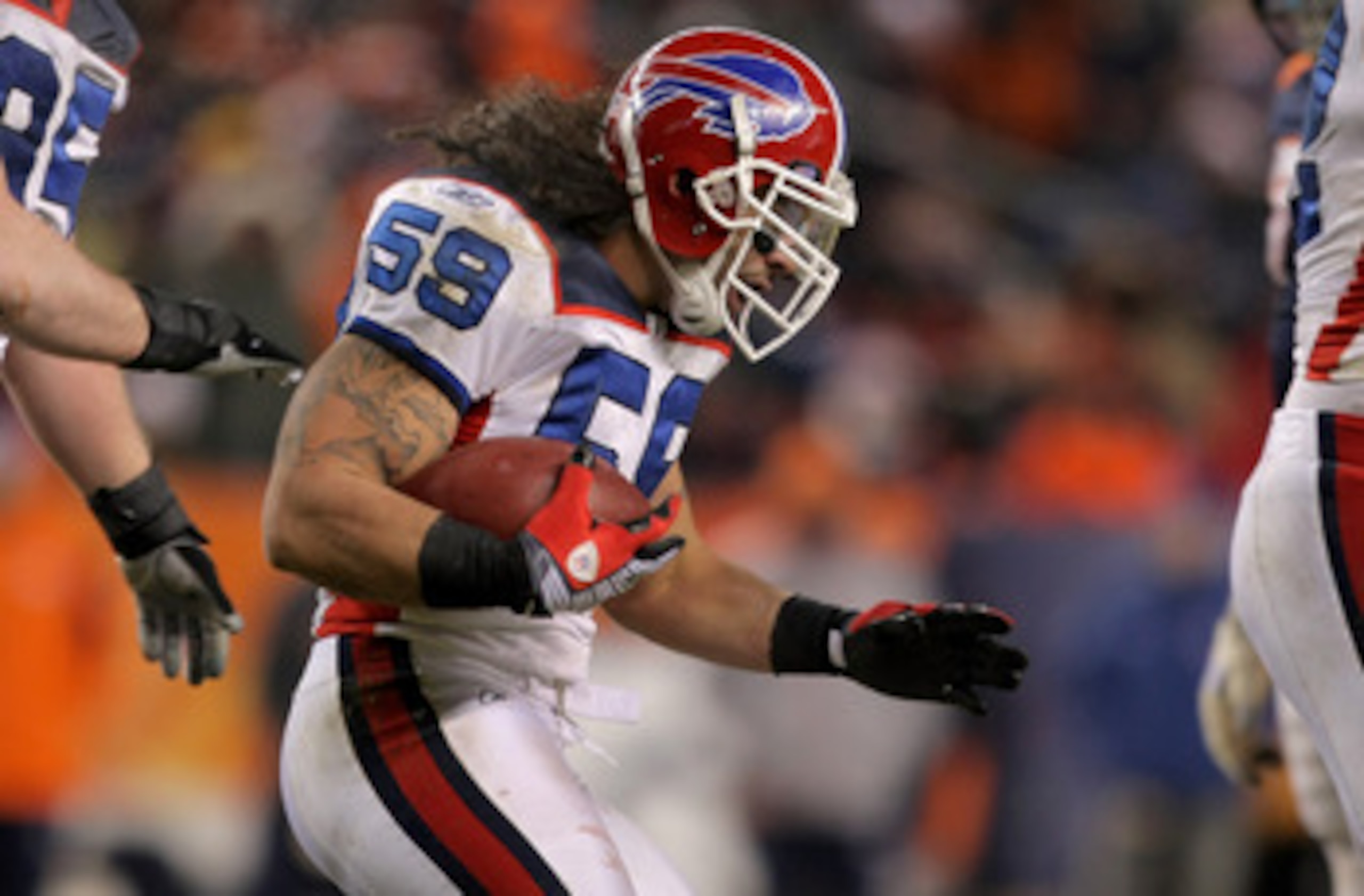 DENVER - DECEMBER 21:  Linebacker Kawika Mitchell #59 of the Buffalo Bills celebrates his interception of a Jay Culter pass late in the fourth quarter to intended receiver Brandon Marshall #15 of the Denver Broncos  at Invesco Field at Mile High on Decemb