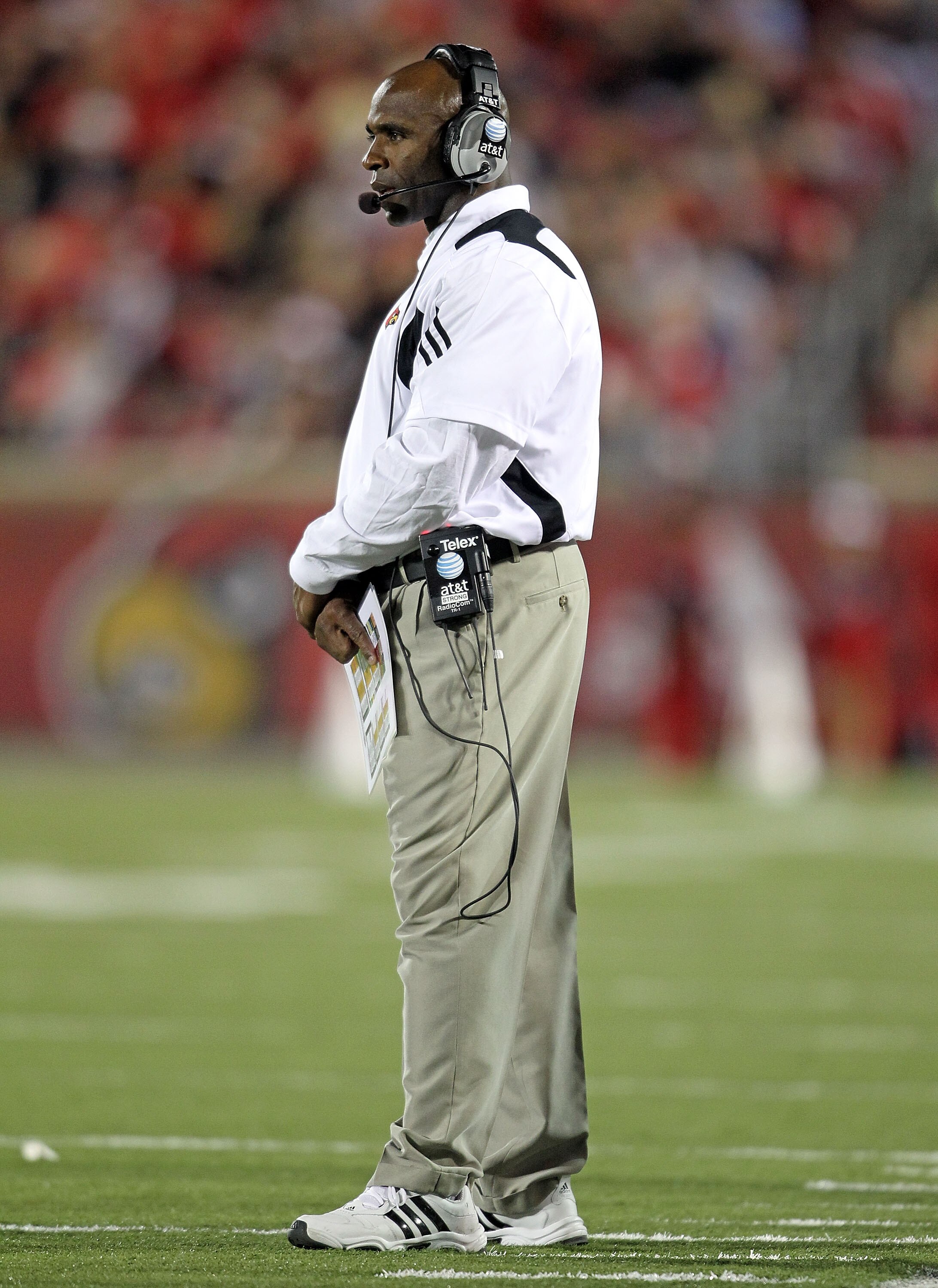 LOUISVILLE, KY - OCTOBER 15:  Charlie Strong the Haed Coach of the Louisville Cardinals gives instructions to his team during the Big East Conference game against the Cincinnati Bearcats at Papa John's Cardinal Stadium on October 15, 2010 in Louisville, K