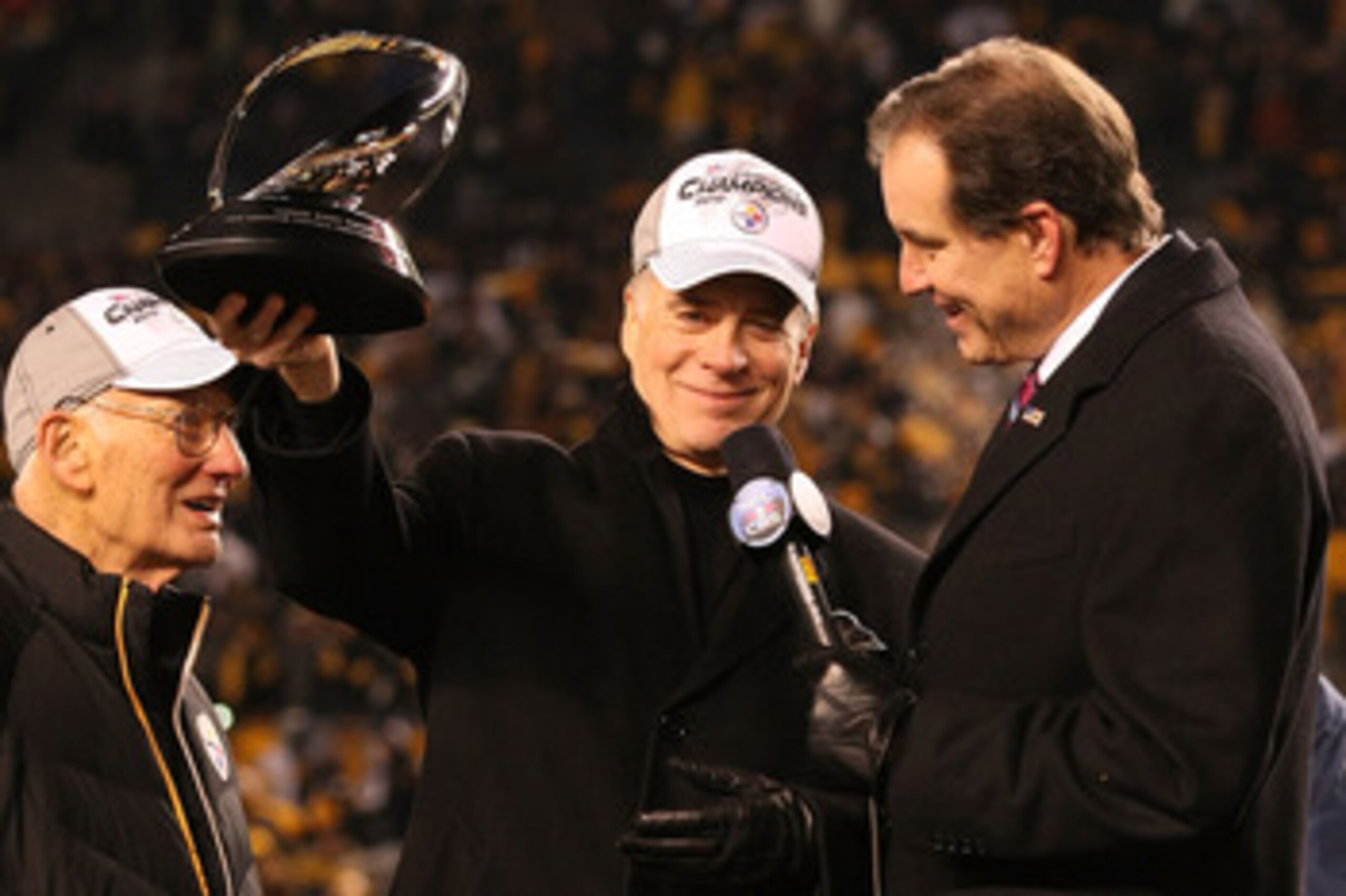 PITTSBURGH, PA - JANUARY 23: Owner Dan Rooney (L) and Team president Art Rooney II (2ndL) of the Pittsburgh Steelers recieve the Lamar Hunt Trophy as CBS sportscaster Jim Nantz looks on after their 24 to 19 win over the New York Jets in the 2011 AFC Cham PITTSBURGH, PA - JANUARY 23: Owner Dan Rooney (L) and Team president Art Rooney II (2ndL) of the Pittsburgh Steelers recieve the Lamar Hunt Trophy as CBS sportscaster Jim Nantz looks on after their 24 to 19 win over the New York Jets in the 2011 AFC Cham