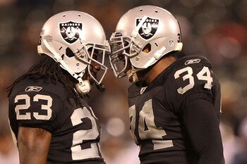OAKLAND, CA - SEPTEMBER 2:  Jeremy Ware #23 and Mike Mitchell #34 of the Oakland Raiders celebrate against the Seattle Seahawks during an NFL preseason game at Oakland-Alameda County Coliseum on September 2, 2010 in Oakland, California.  (Photo by Jed Jac