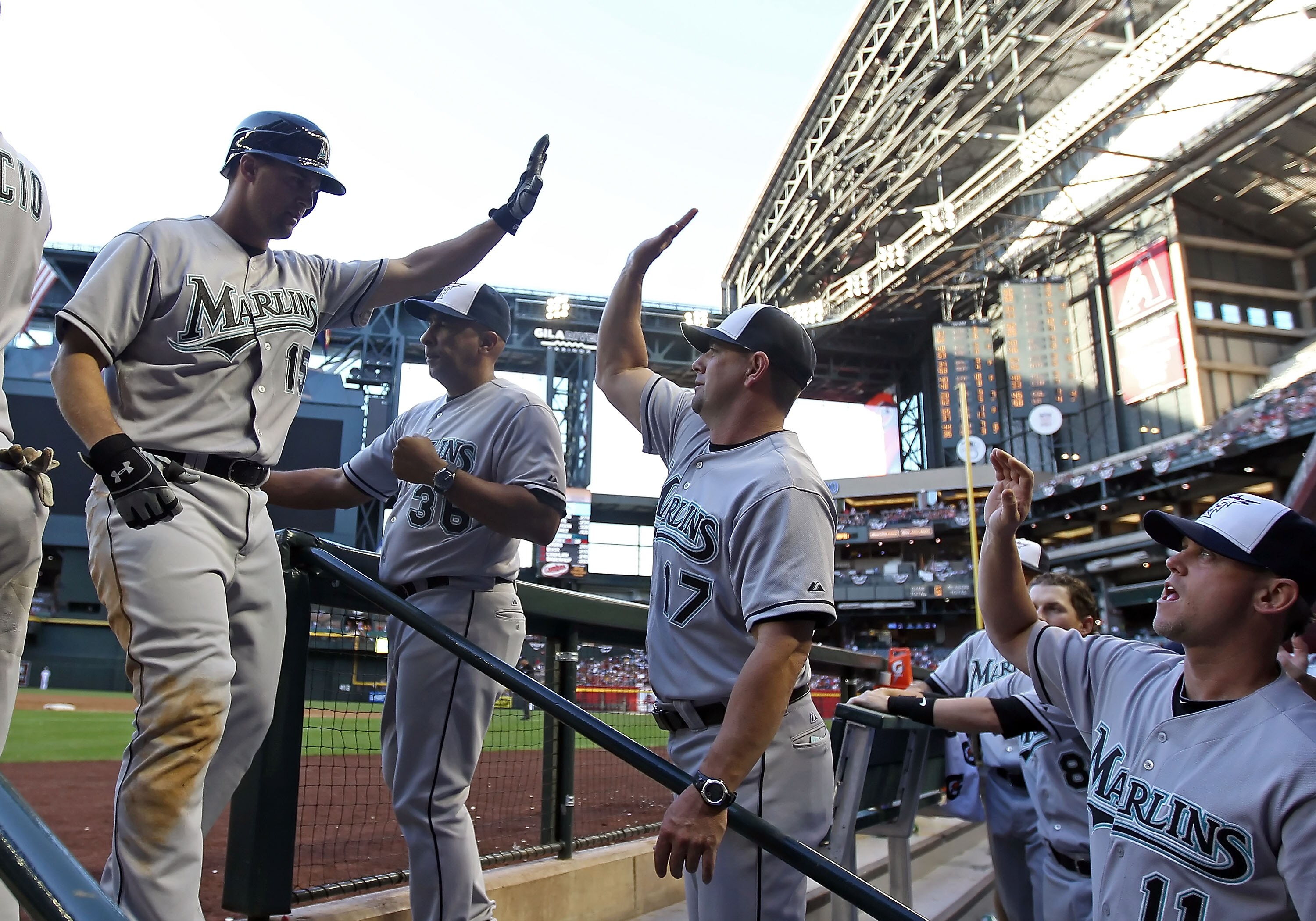 PHOENIX, AZ - MAY 30:  Gaby Sanchez #15 of the Florida Marlins high fives coach Brandon Hyde #17 after hitting a two run home run against the Arizona Diamondbacks during the fifth inning of the Major League Baseball game at Chase Field on May 30, 2011 in