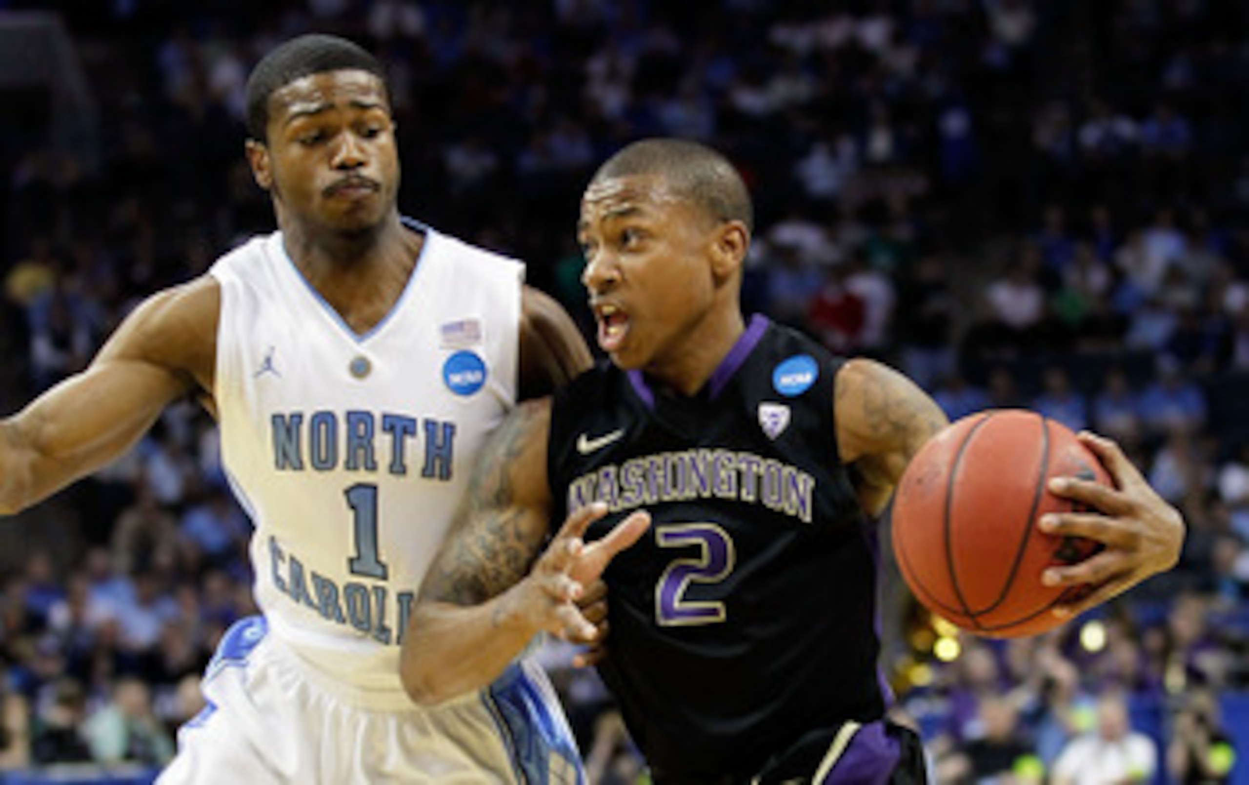 CHARLOTTE, NC - MARCH 20:  Isaiah Thomas #2 of the Washington Huskies drives on Dexter Strickland #1 of the North Carolina Tar Heels during the third round of the 2011 NCAA men's basketball tournament at Time Warner Cable Arena on March 20, 2011 in Charlo