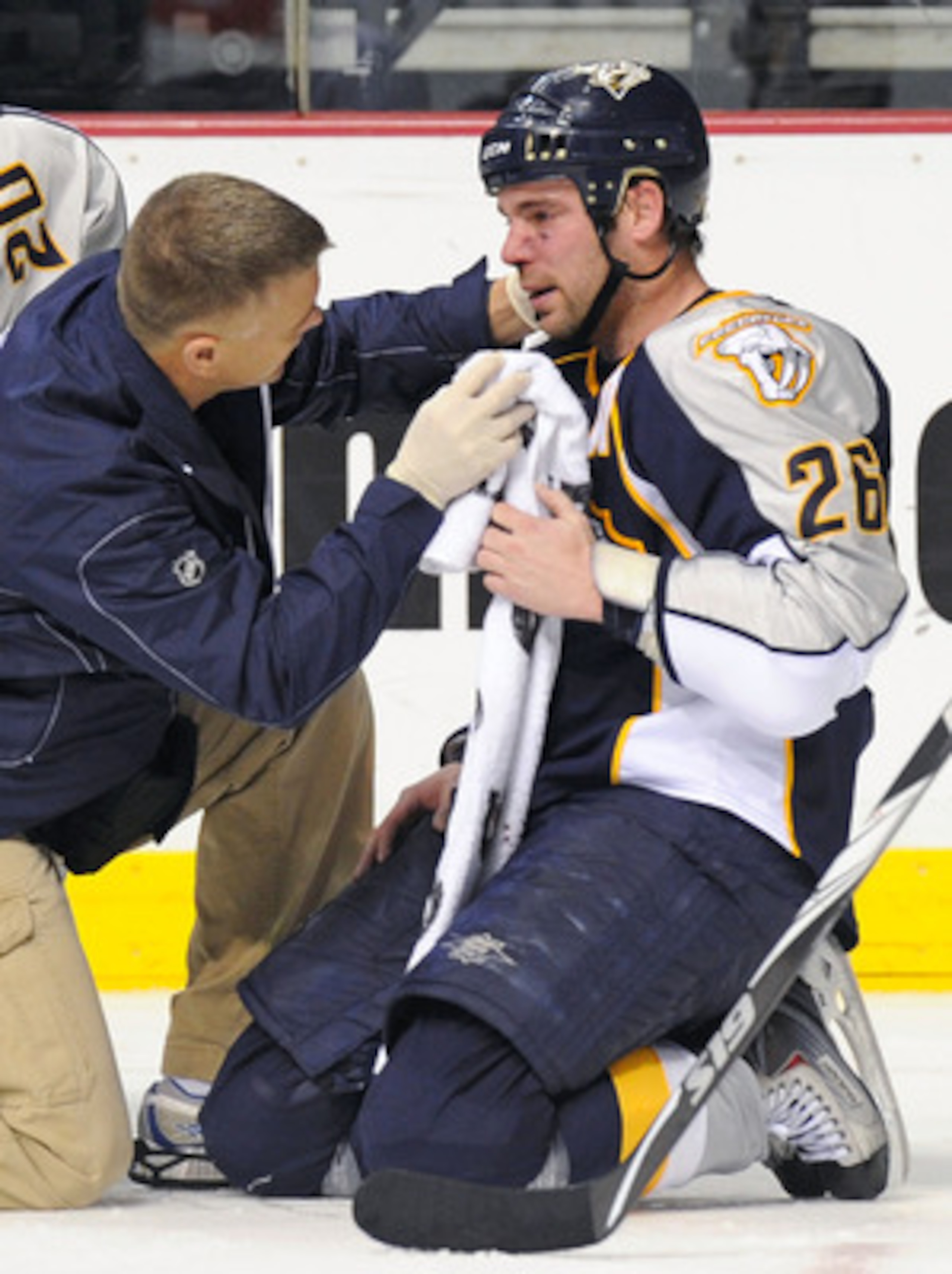 NASHVILLE, TN - FEBRUARY 17:   Trainer Dan Redman examines the eye of Steve Sullivan #26 of the Nashville Predators on February 17, 2011 at the Bridgestone Arena in Nashville, Tennessee.  (Photo by Frederick Breedon/Getty Images)