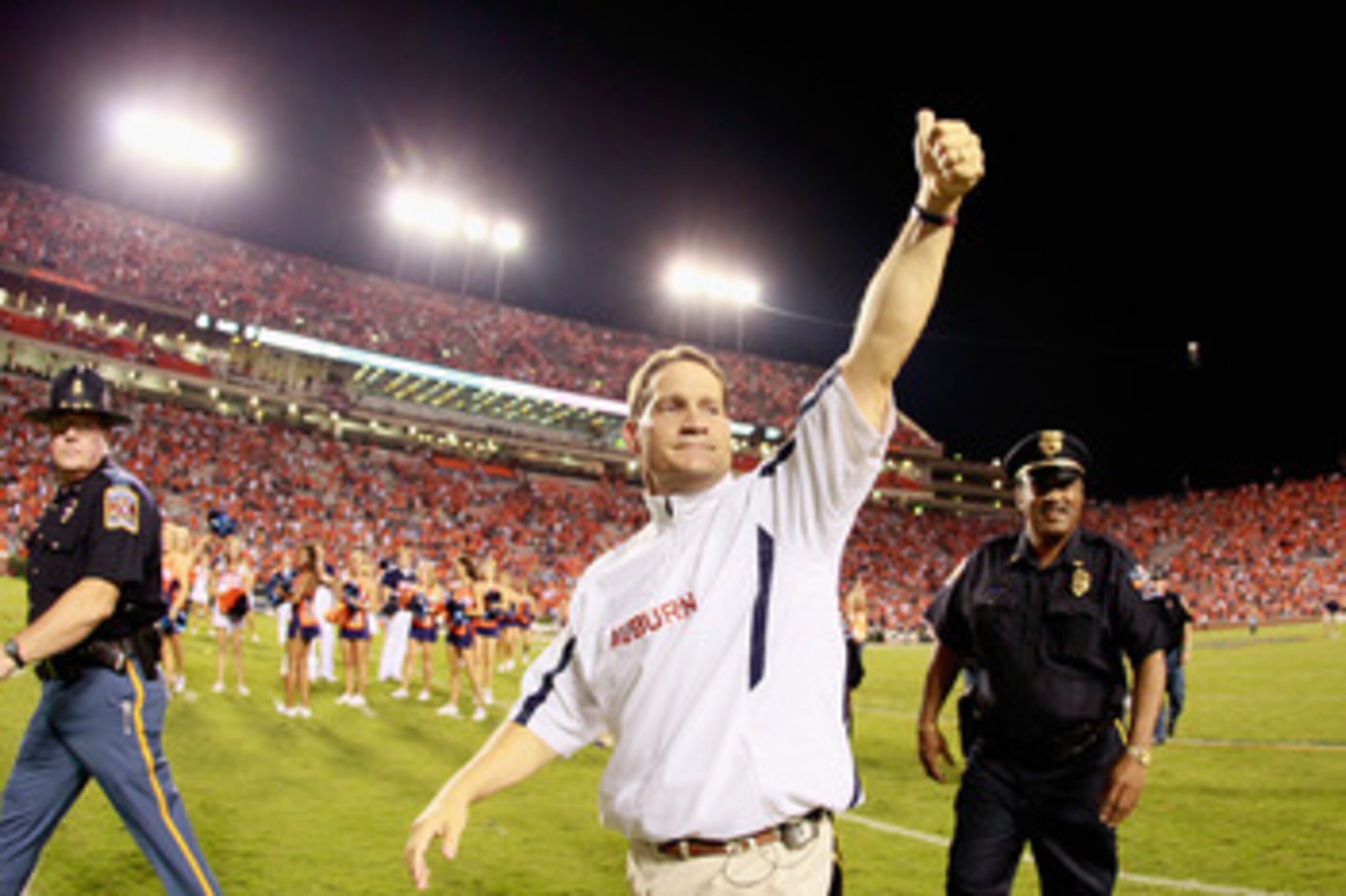 SCOTTSDALE, AZ - JANUARY 11:  Head coach Gene Chizik of the Auburn Tigers poses with the Coaches trophys during a press conference for the Tostitos BCS National Championship Game at the JW Marriott Camelback Inn on January 11, 2011 in Scottsdale, Arizona.