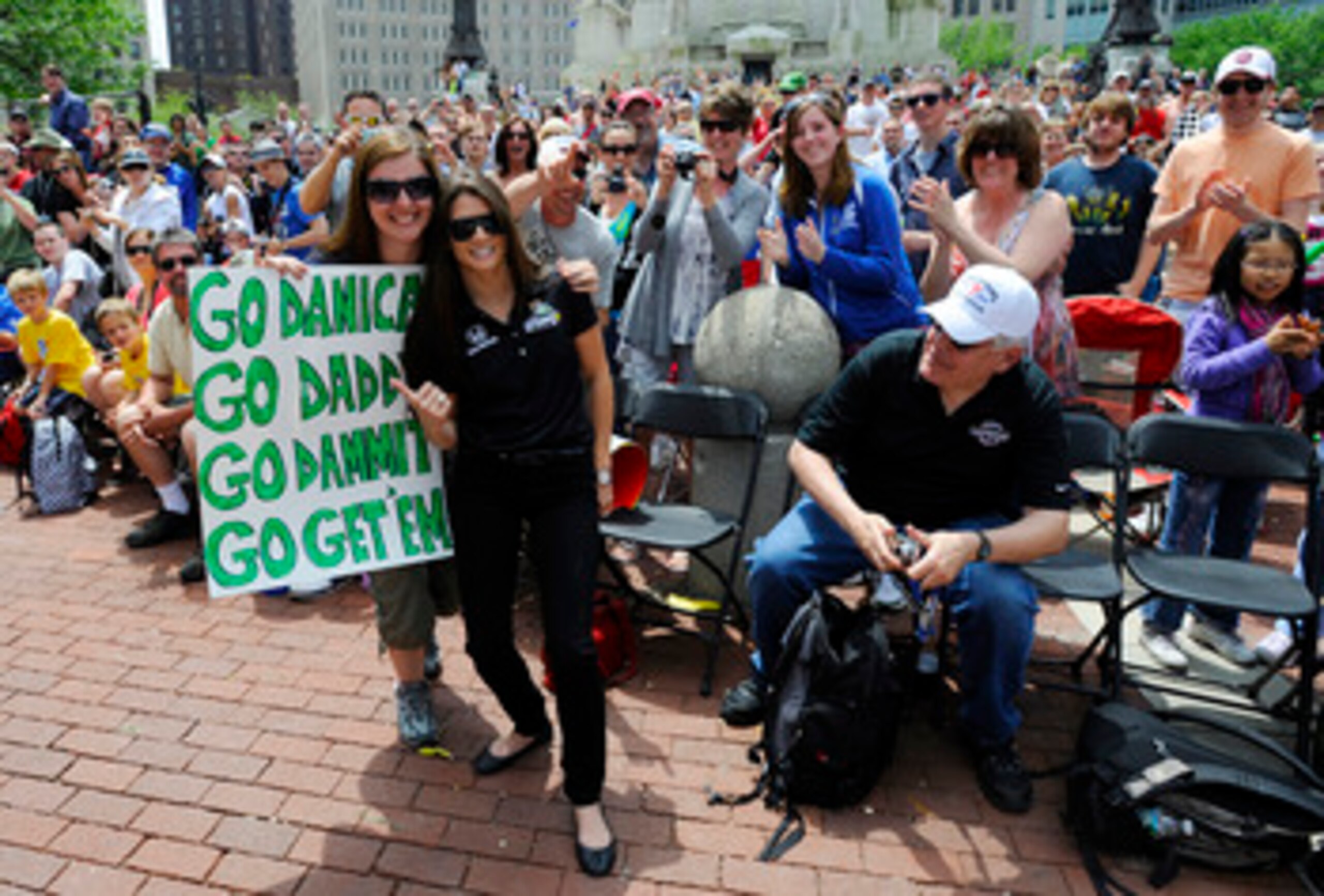 INDIANAPOLIS, IN - MAY 28:  Danica Patrick driver of the #7 Andretti Autosport Dallara Honda poses with fans during the parade for the 100th Anniversary of the Indianapolis 500 on May 28, 2011 in the streets of Indianapolis, Indiana.  (Photo by Robert Lab