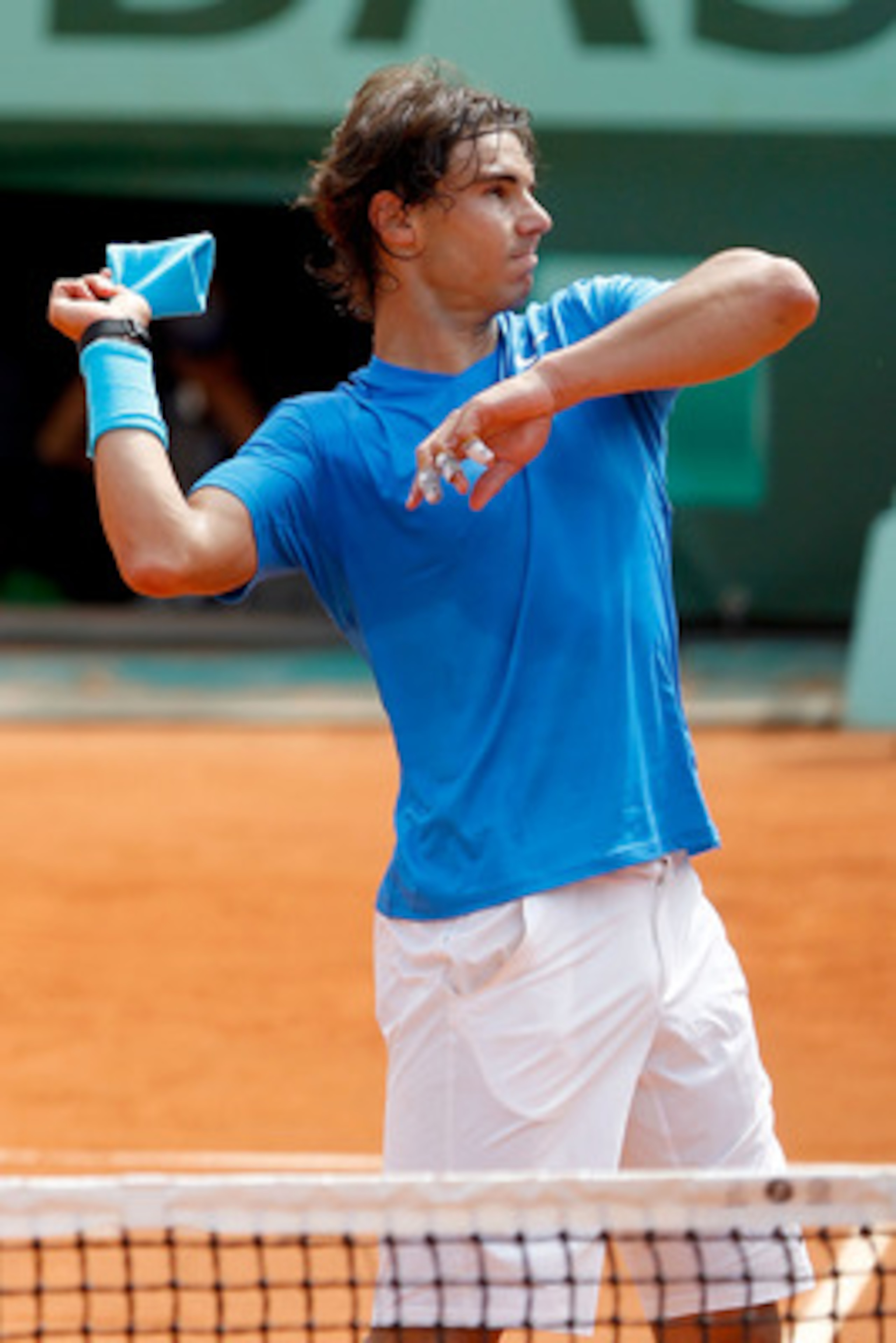 PARIS, FRANCE - MAY 30:  Rafael Nadal of Spain throws his sweatband into the crowd following his victory during the men's singles round four match between Rafael Nadal of Spain and Ivan Lubicic of Croatia on day nine of the French Open at Roland Garros on