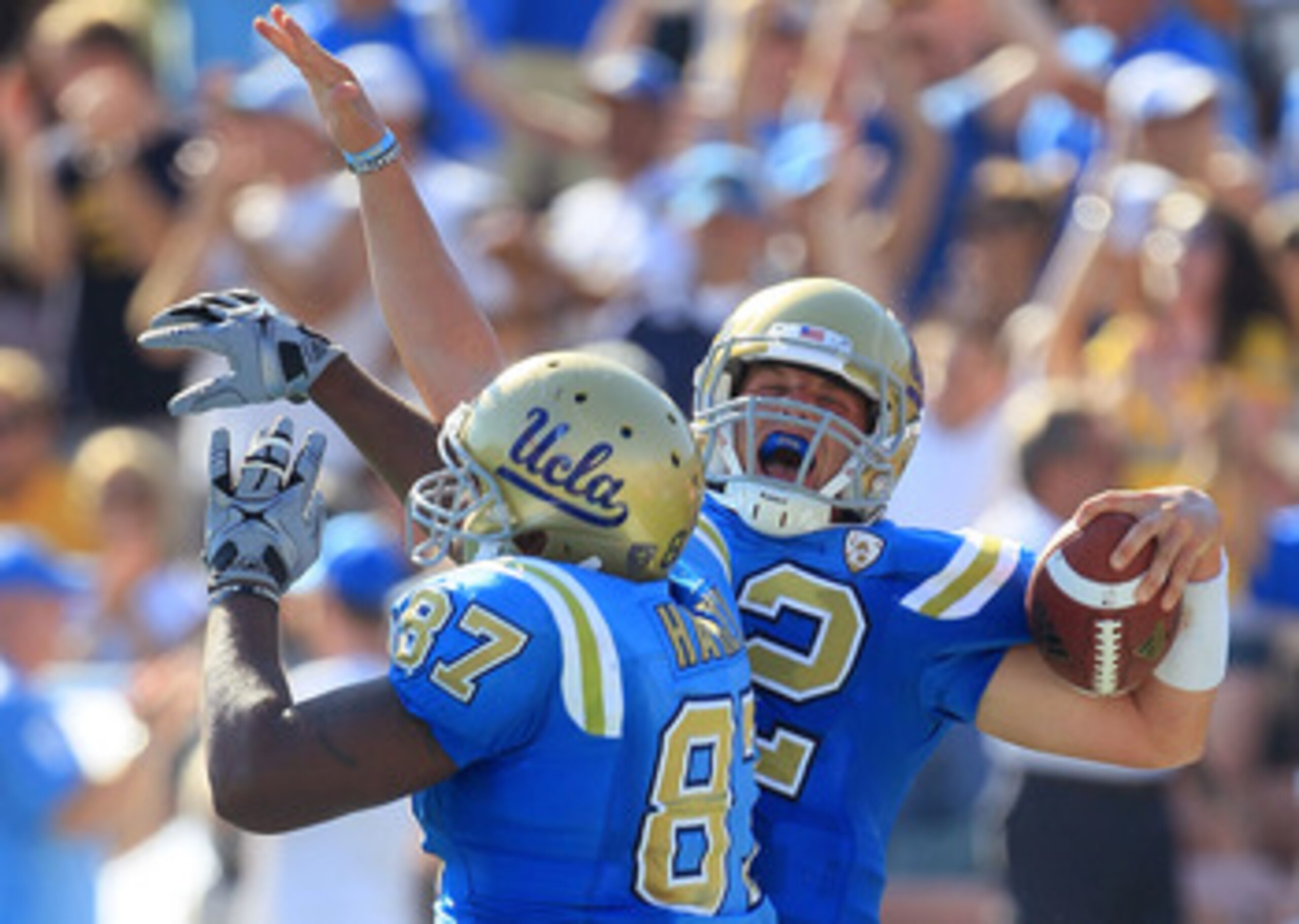 PASADENA, CA - OCTOBER 02:  Quarterback Richard Brehaut #12 of the UCLA Bruins celebrates a touchdown with teammate Cory Harkey #87 against the Washington State Cougars during the game at the Rose Bowl on October 2, 2010 in Pasadena, California. UCLA defe