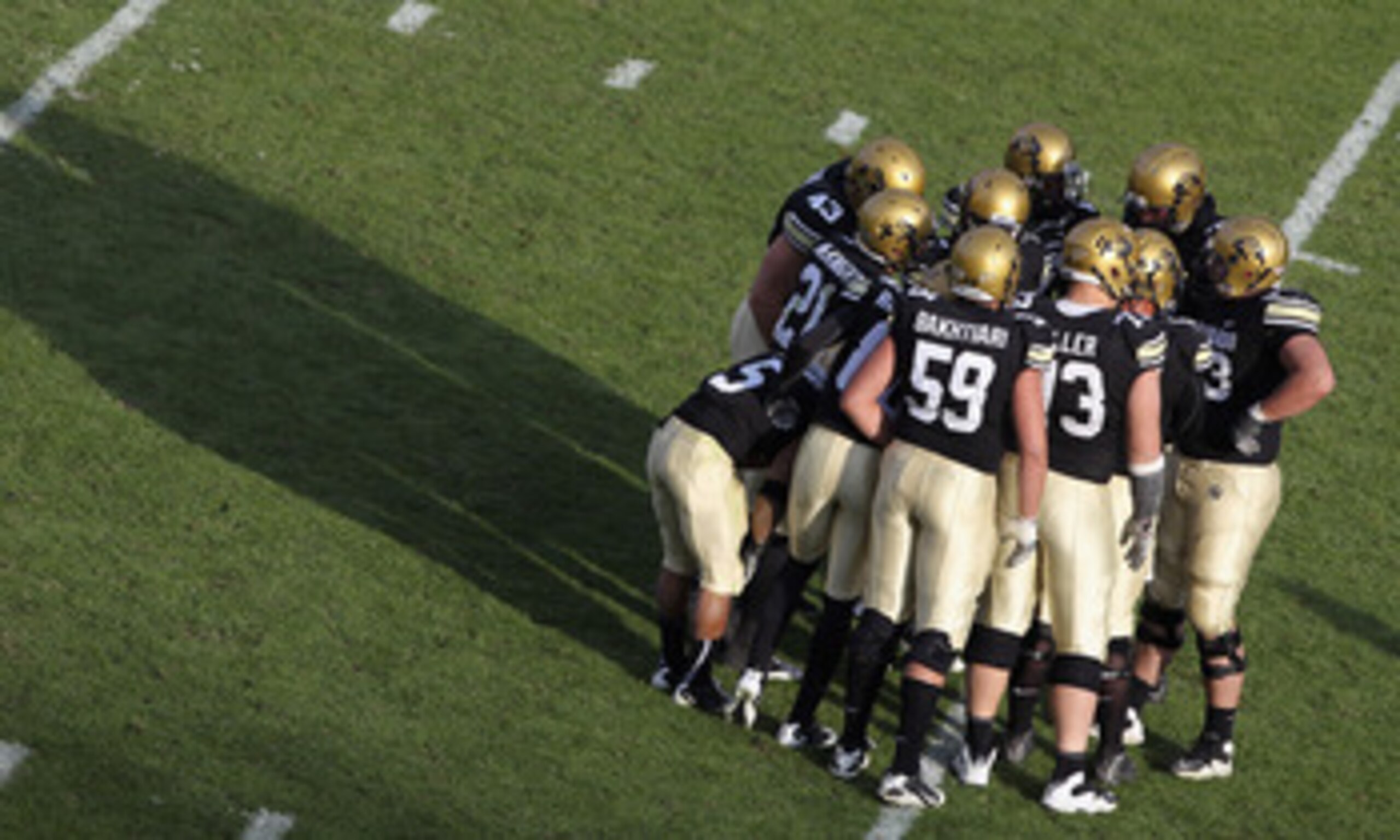BOULDER, CO - NOVEMBER 20:  The Colorado Buffaloes offenses huddles up against the Kansas State Wildcats at Folsom Field on November 20, 2010 in Boulder, Colorado. Colorado defeated Kansas State 44-36.  (Photo by Doug Pensinger/Getty Images)