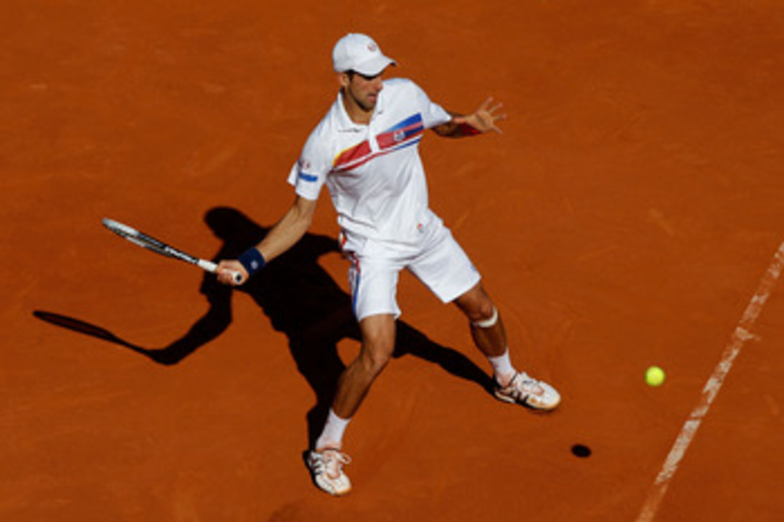 PARIS, FRANCE - MAY 29:  Novak Djokovic of Serbia hits a forehand during the men's singles round four match between Richard Gasquet of France and Novak Djokovic of Serbia on day eight of the French Open at Roland Garros on May 29, 2011 in Paris, France.