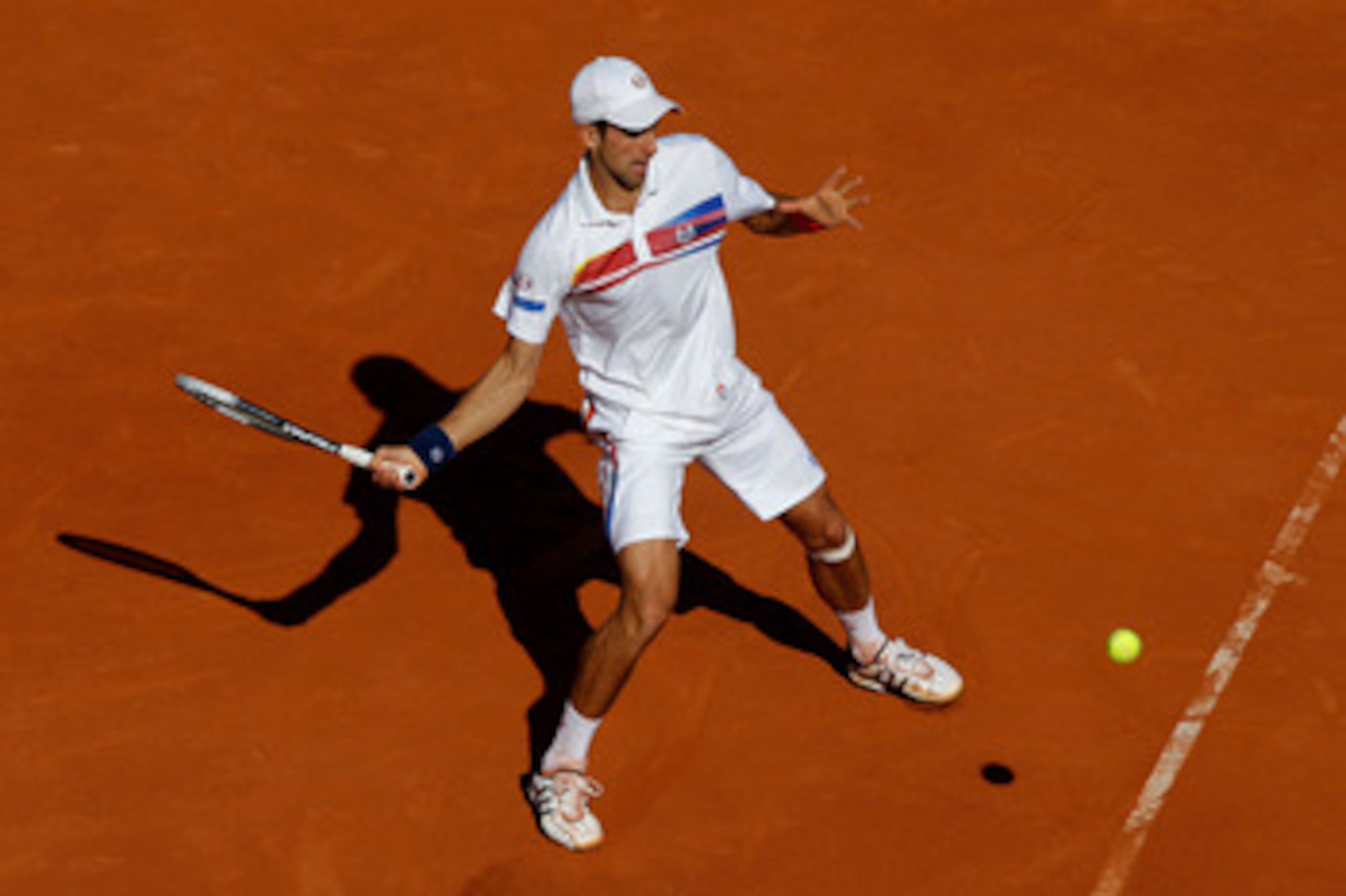 PARIS, FRANCE - MAY 29:  Novak Djokovic of Serbia hits a forehand during the men's singles round four match between Richard Gasquet of France and Novak Djokovic of Serbia on day eight of the French Open at Roland Garros on May 29, 2011 in Paris, France.