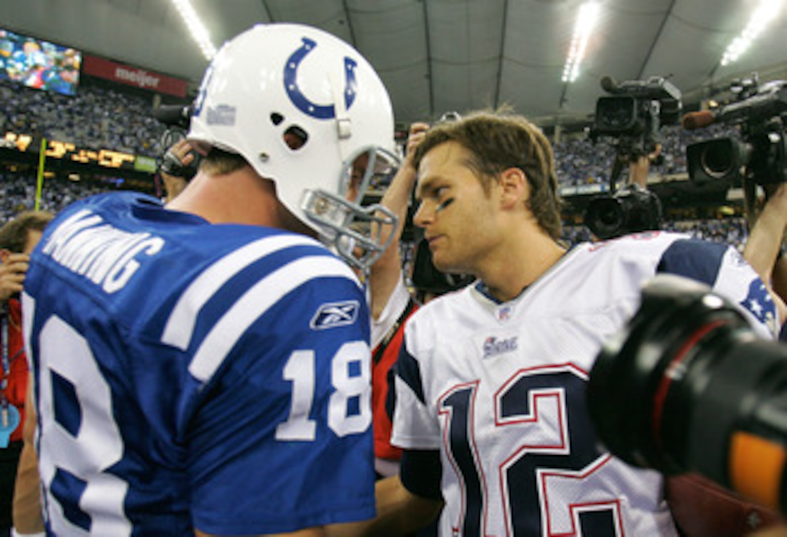 INDIANAPOLIS - NOVEMBER 04:  Peyton Manning #18 of the Indianapolis Colts and Tom Brady #12 of the New England Patriots meets on the field after the Patriots won their game 24-20 on November 4, 2007 at the RCA Dome in Indianapolis, Indiana.  (Photo by And