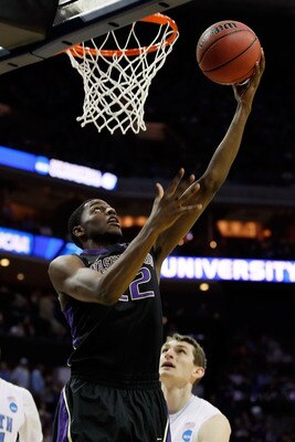CHARLOTTE, NC - MARCH 20:  Justin Holiday #22 of the Washington Huskies lays the ball up against the North Carolina Tar Heels in the second half during the third round of the 2011 NCAA men's basketball tournament at Time Warner Cable Arena on March 20, 20