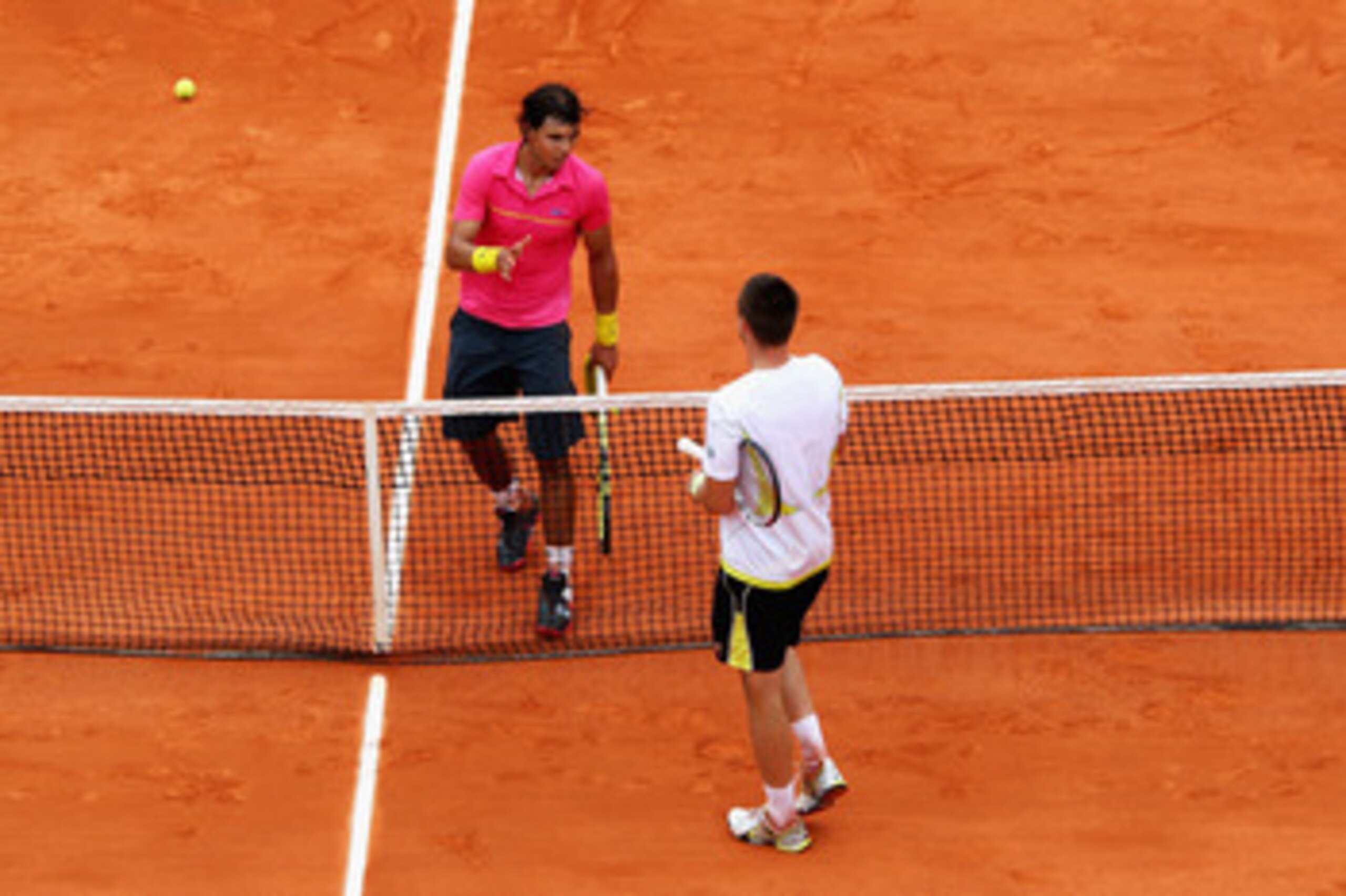 PARIS - MAY 31: Robin Soderling (below net) of Sweden goes to shake hands with Rafael Nadal of Spain following his victory during the Men's Singles Fourth Round match on day eight of the French Open at Roland Garros on May 31, 2009 in Paris, France. (P PARIS - MAY 31: Robin Soderling (below net) of Sweden goes to shake hands with Rafael Nadal of Spain following his victory during the Men's Singles Fourth Round match on day eight of the French Open at Roland Garros on May 31, 2009 in Paris, France. (P