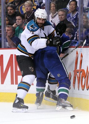 VANCOUVER, CANADA - MAY 24:  Niclas Wallin #7 of the San Jose Sharks finishes his check in Game Five of the Western Conference Finals against the Vancouver Canucks during the 2011 Stanley Cup Playoffs at Rogers Arena on May 24, 2011 in Vancouver, British