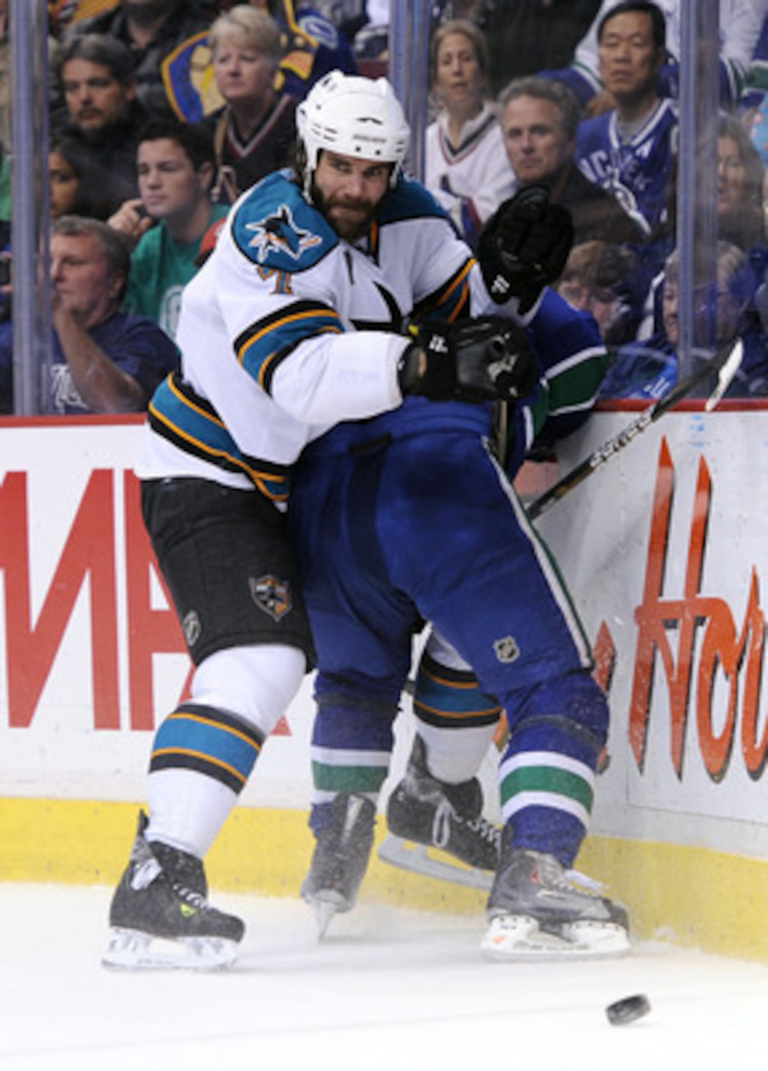 VANCOUVER, CANADA - MAY 24:  Niclas Wallin #7 of the San Jose Sharks finishes his check in Game Five of the Western Conference Finals against the Vancouver Canucks during the 2011 Stanley Cup Playoffs at Rogers Arena on May 24, 2011 in Vancouver, British