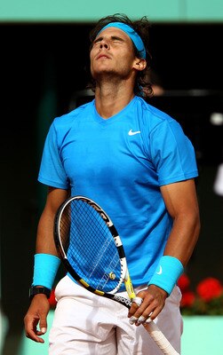 PARIS, FRANCE - MAY 24:  Rafael Nadal of Spain shows his dejection during the men's singles round one match between Rafael Nadal of Spain and John Isner of USA on day three of the French Open at Roland Garros on May 24, 2011 in Paris, France.  (Photo by C