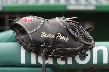 WASHINGTON, DC - APRIL 29:  The glove of catcher Buster Posey #28 of the San Francisco Giants rests on the railing in the dugout before the start of the Gaints game against the Washington Nationals at Nationals Park on April 29, 2011 in Washington, DC.  (