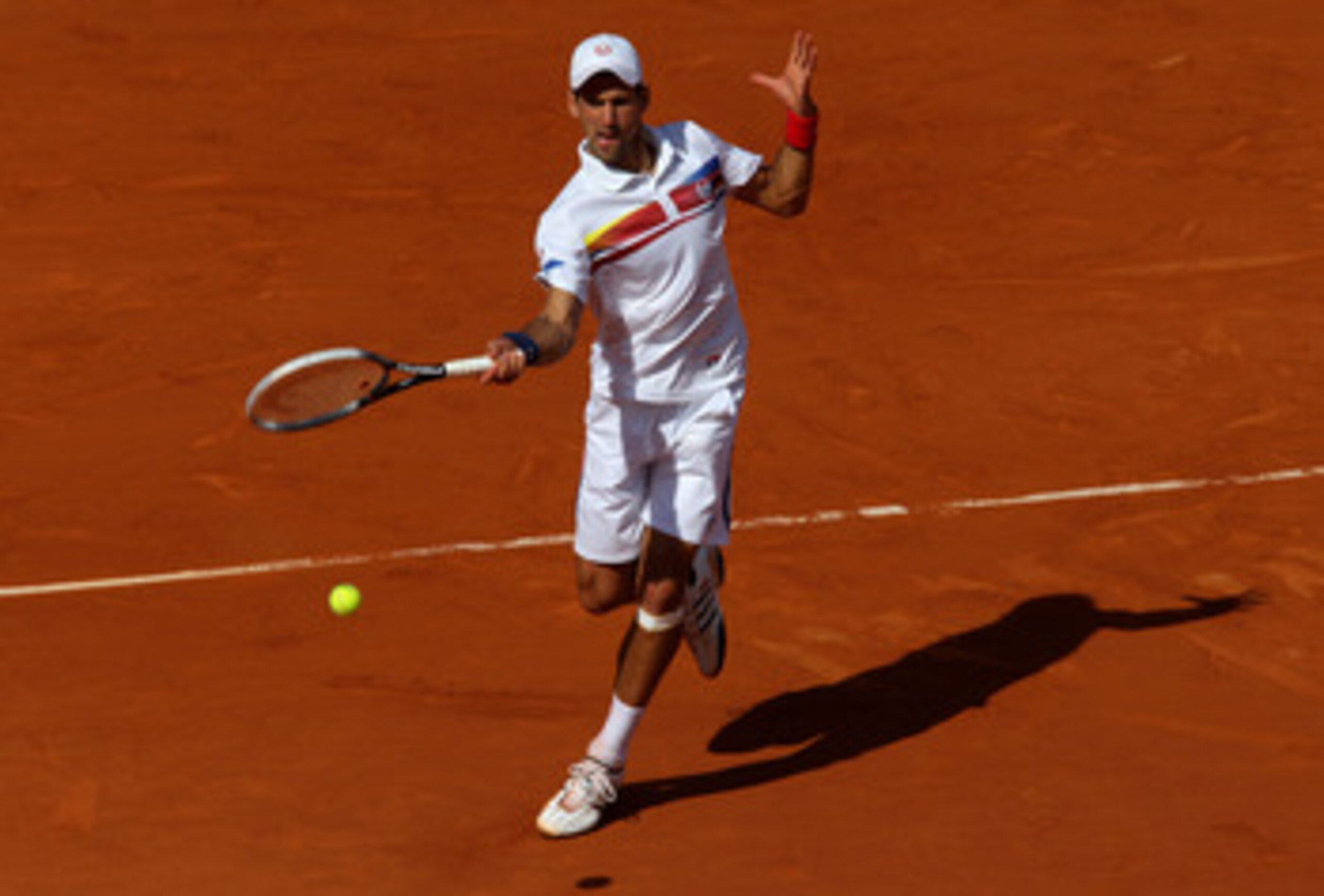 PARIS, FRANCE - MAY 29:  Novak Djokovic of Serbia hits a forehand during the men's singles round four match between Richard Gasquet of France and Novak Djokovic of Serbia on day eight of the French Open at Roland Garros on May 29, 2011 in Paris, France.