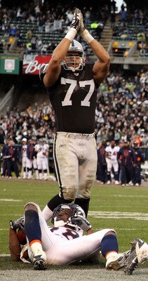 OAKLAND, CA - DECEMBER 19:  Quentin Groves #52 of the Oakland Raiders celebrates with Kamerion Wimbley #96 and Matt Shaughnessy #77 after he stopped Correll Buckhalter #28 of the Denver Broncos for a safety at Oakland-Alameda County Coliseum on December 1