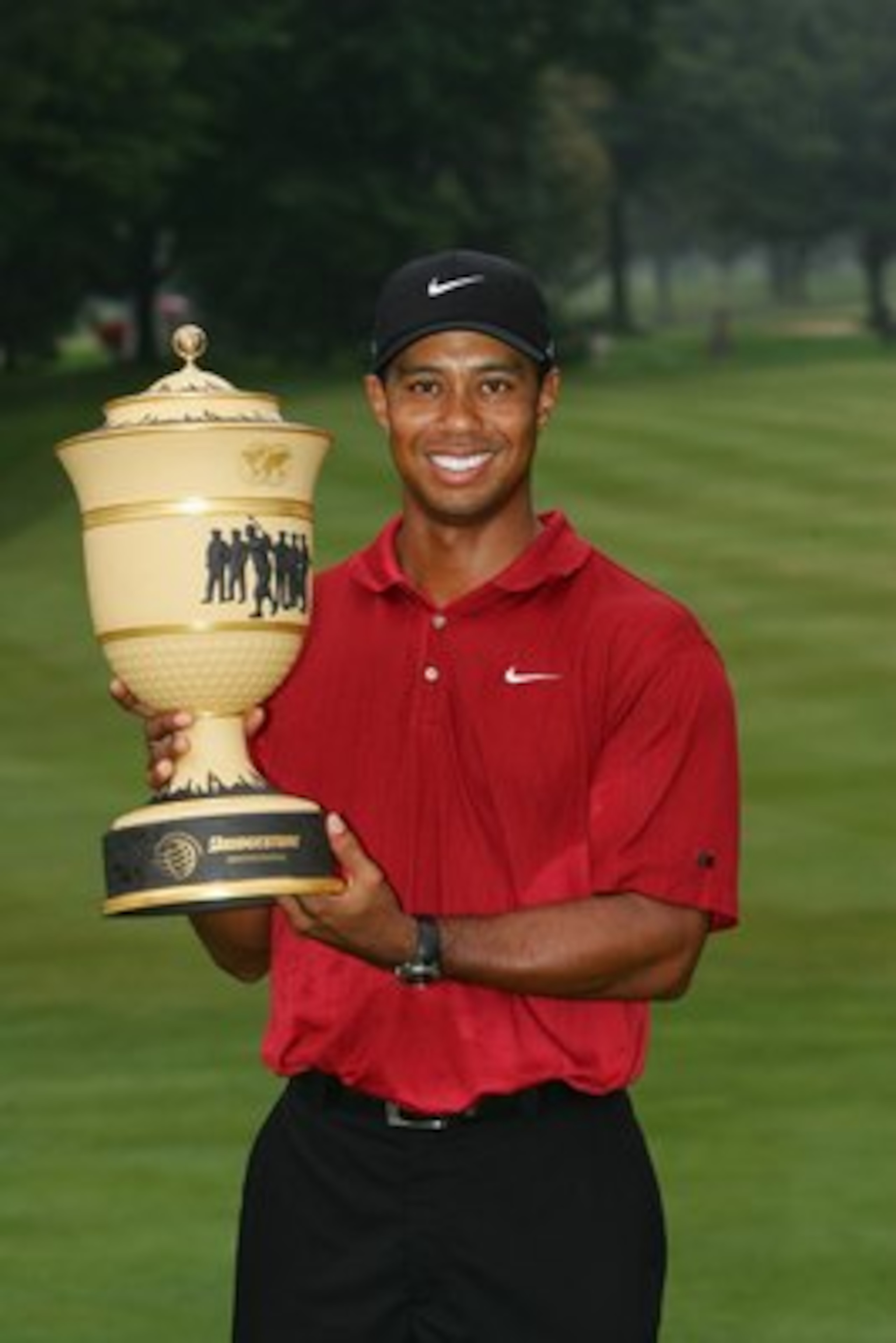AKRON, OH - AUGUST 05: Tiger Woods holds the trophy after winning the WGC-Bridgestone Invitational on August 5, 2007 at Firestone Country Club in Akron, Ohio.  (Photo by Sam Greenwood/Getty Images)