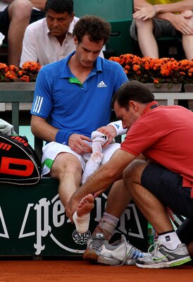 PARIS, FRANCE - MAY 30:  Andy Murray of Great Britain receives treatment on his injured ankle during the men's singles round four match between Andy Murray of Great Britain and Victor Troicki of Serbia on day nine of the French Open at Roland Garros on Ma