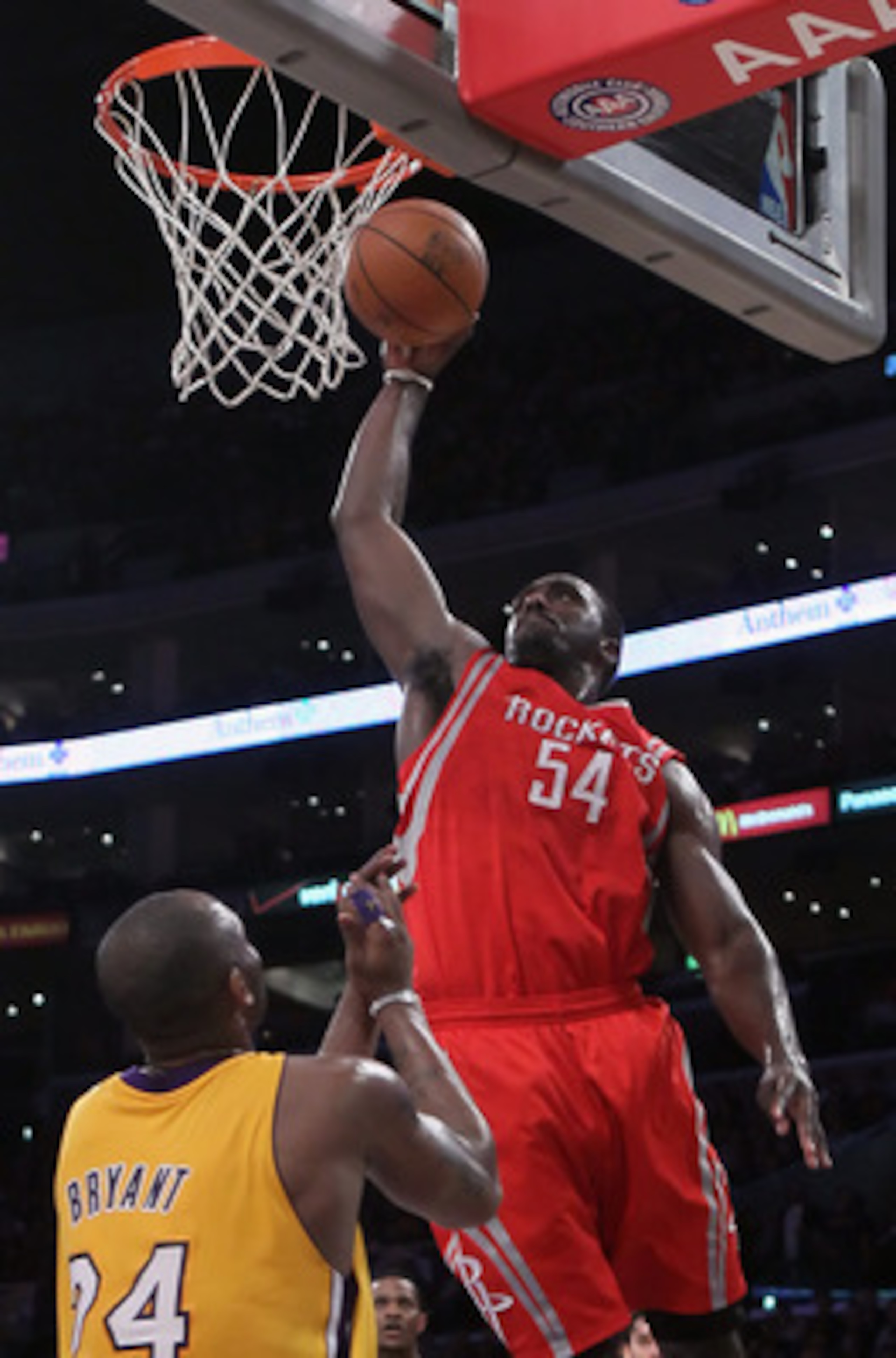 LOS ANGELES, CA - FEBRUARY 01:  Patrick Patterson #54 of the Houston Rockets drives over Kobe Bryant #24 of the Los Angeles Lakers for a dunk in the first half at Staples Center on February 1, 2011 in Los Angeles, California. NOTE TO USER: User expressly
