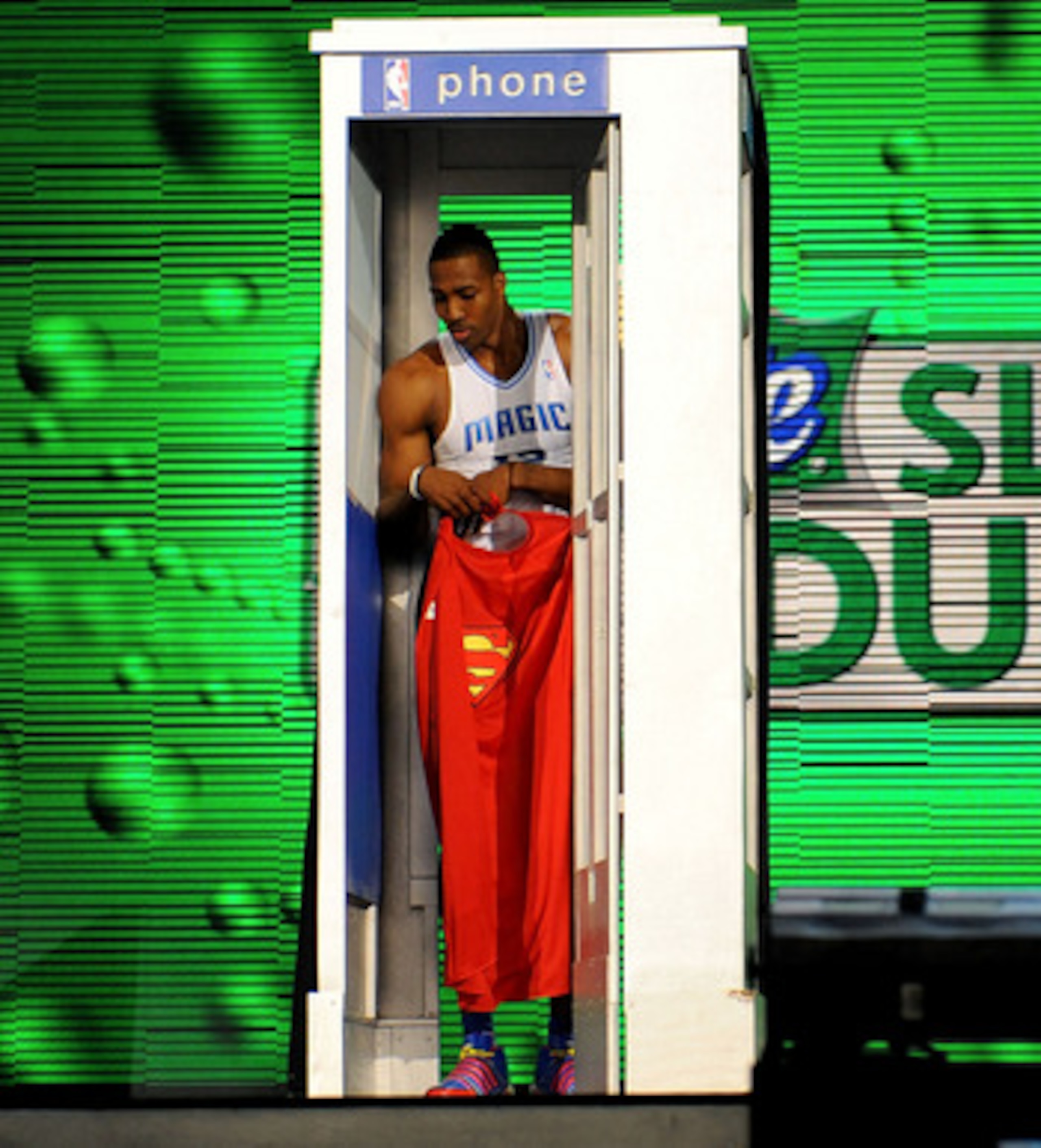 PHOENIX - FEBRUARY 14:  Dwight Howard of the Orlando Magic emerges from a phone booth wearing a Superman cape during the Sprite Slam Dunk Contest on All-Star Saturday Night, part of 2009 NBA All-Star Weekend at US Airways Center on February 14, 2009 in Ph