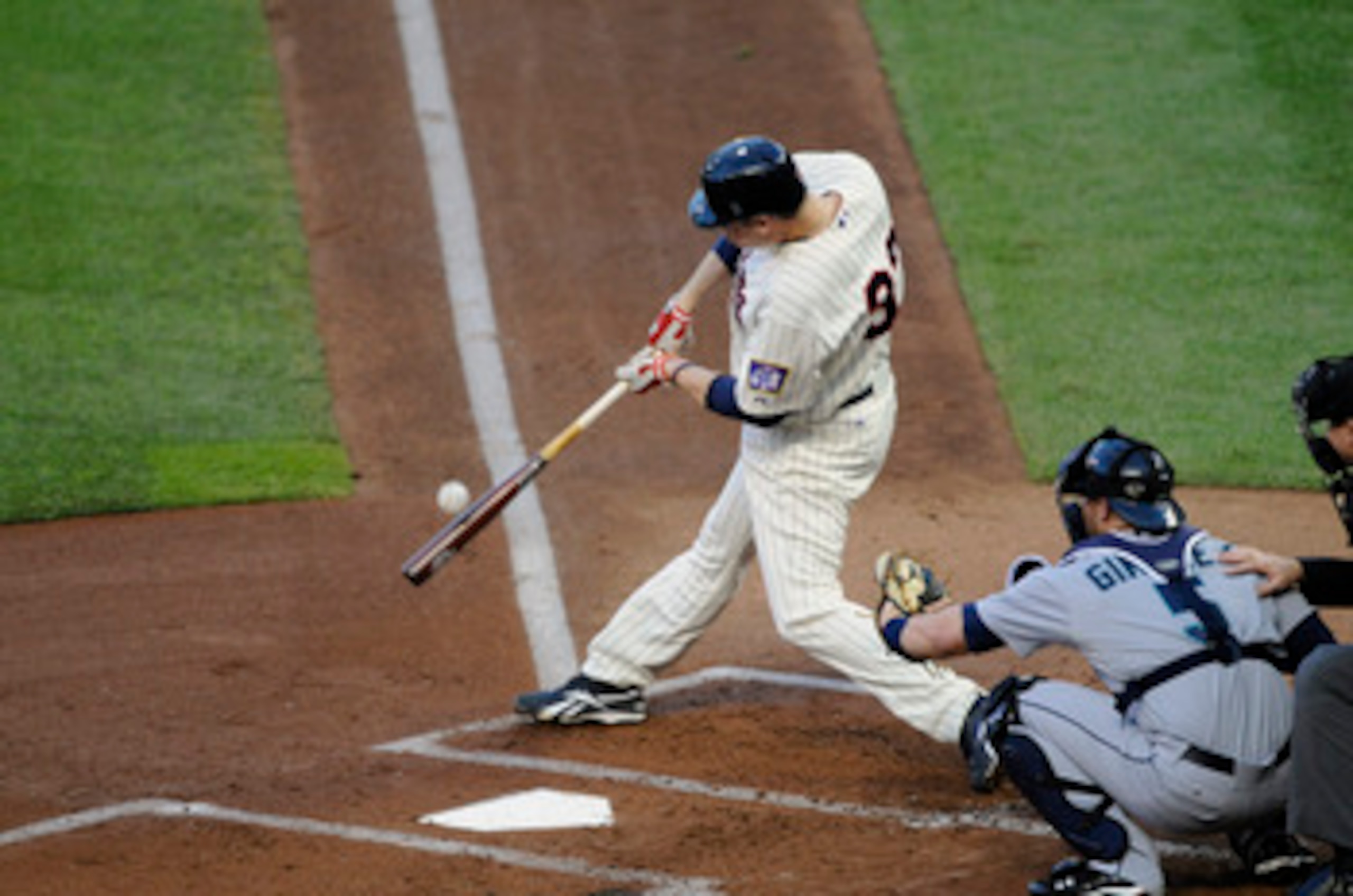 MINNEAPOLIS, MN - MAY 23: Justin Morneau #33 of the Minnesota Twins bats while catcher Chris Gimenez #5 of the Seattle Mariners defends home plate during their game on May 23, 2011 at Target Field in Minneapolis, Minnesota. The Rockies won 6-5. (Photo by