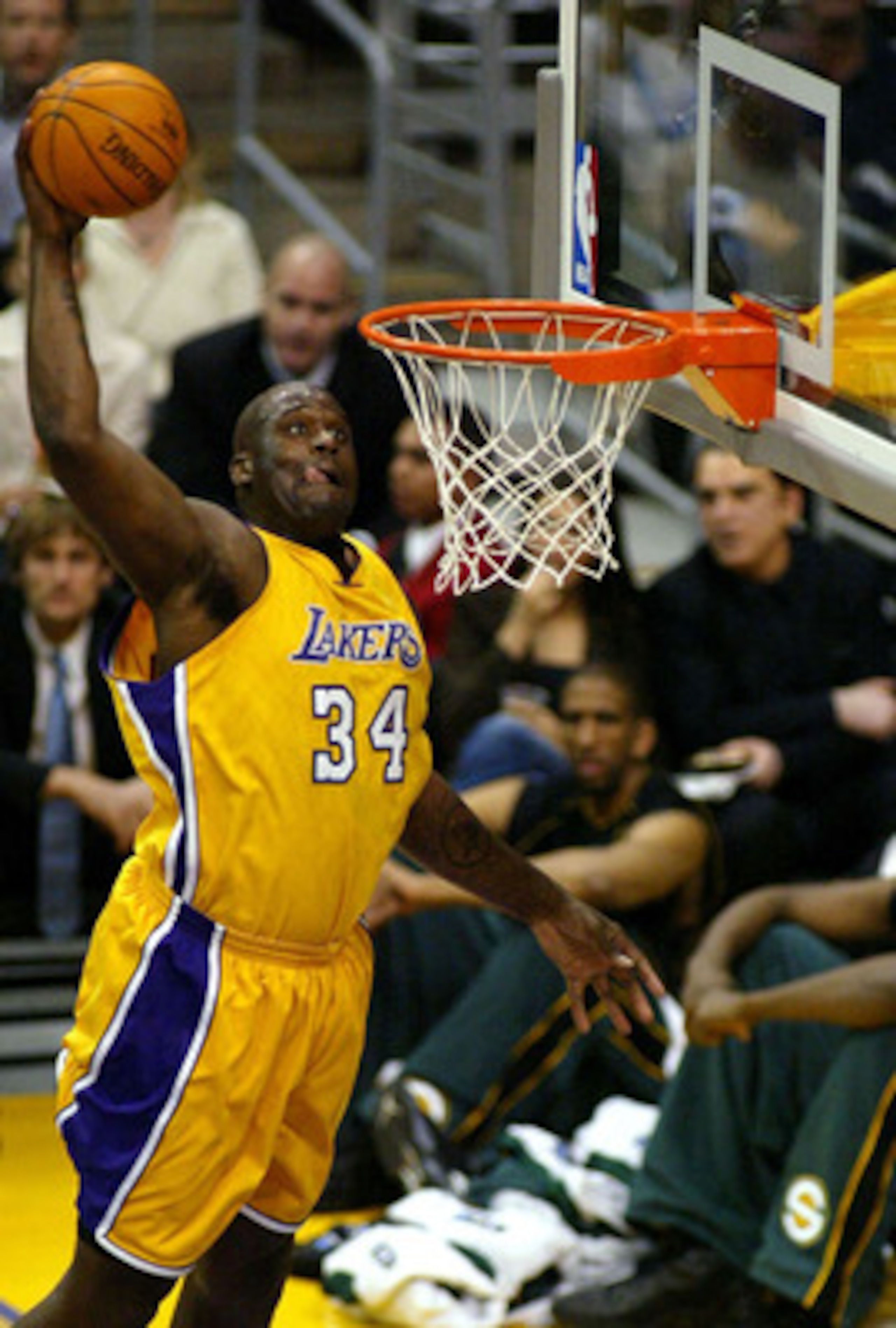 LOS ANGELES - MARCH  5:  Shaquille O'Neal #34 of the Los Angeles Lakers slam dunks during the game against the Seattle Sonics at Staples Center on March 5, 2004 in Los Angeles, California.  NOTE TO USER: User expressly acknowledges and agrees that, by dow
