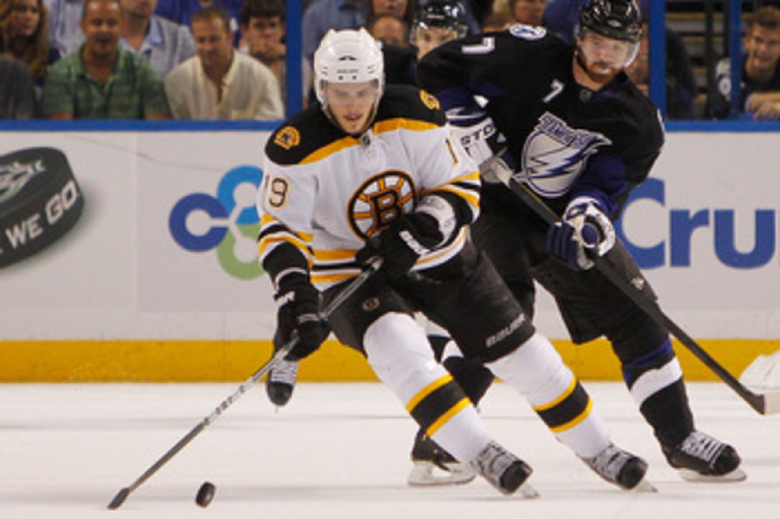 TAMPA, FL - MAY 19:  Tyler Seguin #19 of the Boston Bruins controls the puck in front of Brett Clark #7 of the Tampa Bay Lightning in Game Three of the Eastern Conference Finals during the 2011 NHL Stanley Cup Playoffs at St Pete Times Forum on May 19, 20
