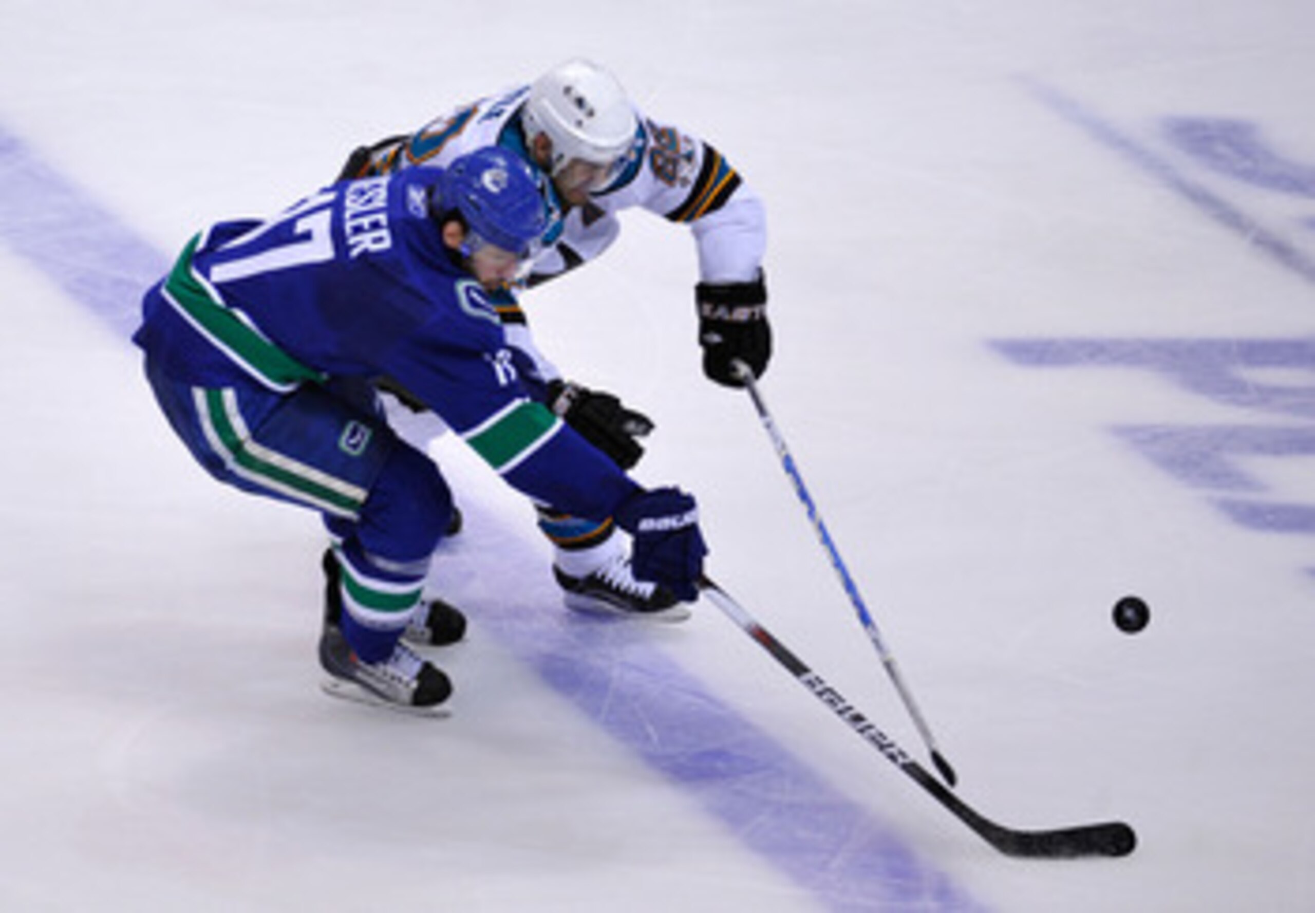 VANCOUVER, CANADA - MAY 24:  Ryan Kesler #17 of the Vancouver Canucks and Dan Boyle #22 of the San Jose Sharks vie for the puck in Game Five of the Western Conference Finals during the 2011 Stanley Cup Playoffs at Rogers Arena on May 24, 2011 in Vancouver