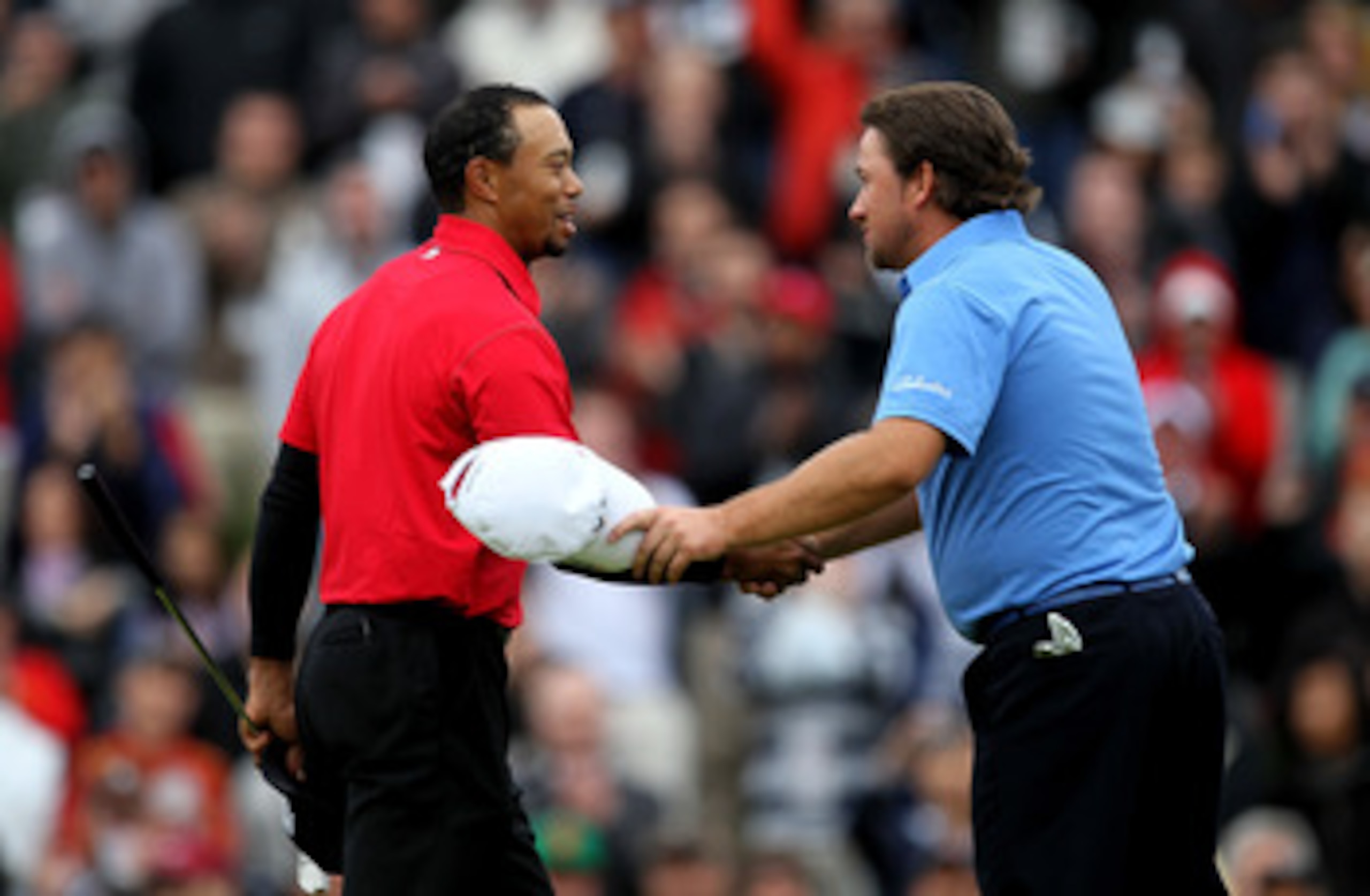 THOUSAND OAKS, CA - DECEMBER 05:  Graeme McDowell of Northern Ireland (R) and Tiger Woods shake hands on the 18th green after they finished regulation in a tie during the final round of the Chevron World Challenge at Sherwood Country Club on December 5, 2