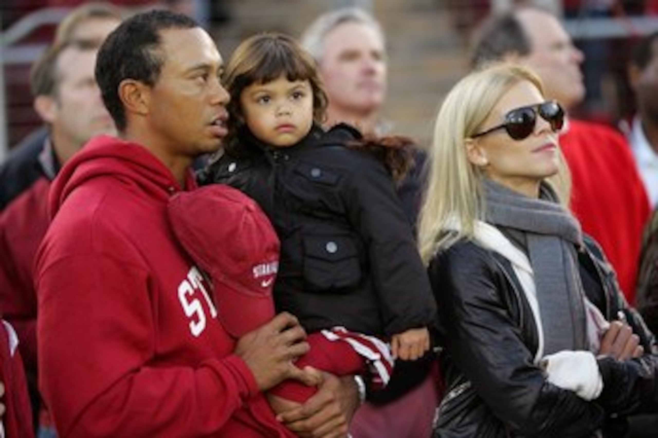 PALO ALTO, CA - NOVEMBER 21:  Honorary Standford Cardinal captain Tiger Woods his daugher, Sam, and wife, Elin Nordegren, stand on the sidelines before the Cardinal game against the California Bears at Stanford Stadium on November 21, 2009 in Palo Alto, C