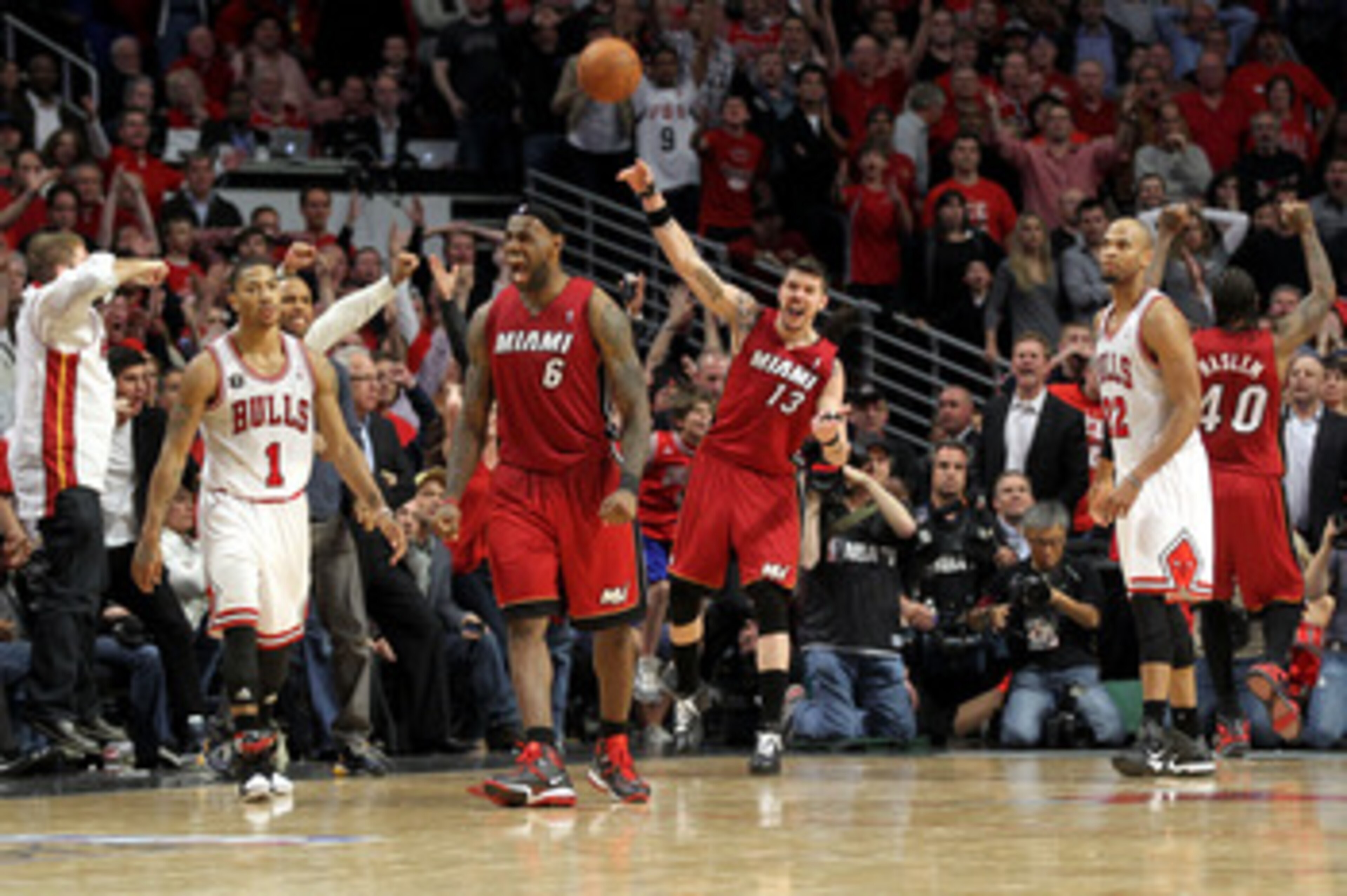 CHICAGO, IL - MAY 26:  LeBron James #6 and Mike Miller #13 of the Miami Heat celebrte after they won 83-80 against Derrick Rose #1 (L) and Taj Gibson (R) #22 of the Chicago Bulls in Game Five of the Eastern Conference Finals during the 2011 NBA Playoffs o