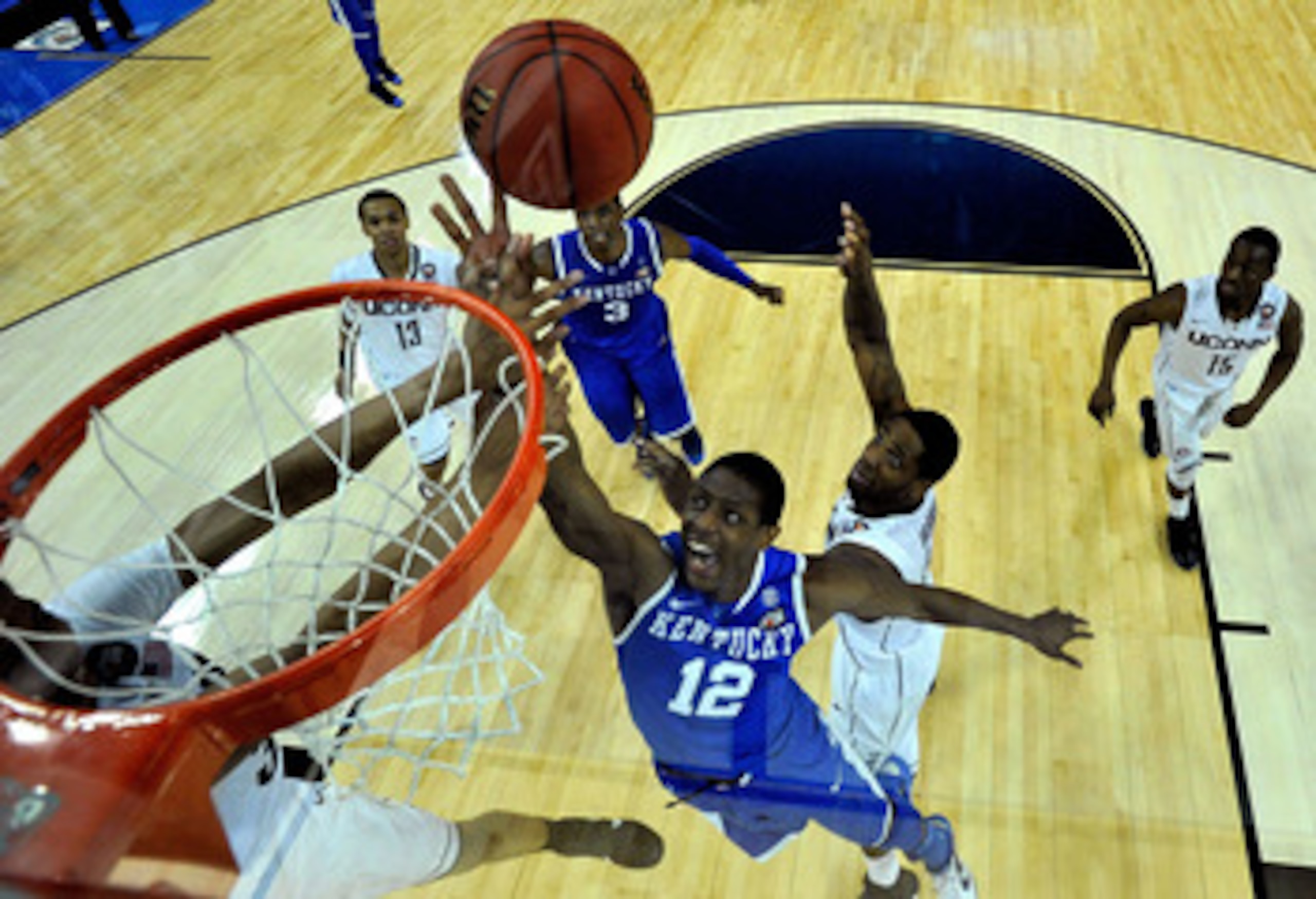 HOUSTON, TX - APRIL 02: Brandon Knight #12 of the Kentucky Wildcats goes to the hoop against Alex Oriakhi #34 of the Connecticut Huskies during the National Semifinal game of the 2011 NCAA Division I Men's Basketball Championship at Reliant Stadium on Ap HOUSTON, TX - APRIL 02: Brandon Knight #12 of the Kentucky Wildcats goes to the hoop against Alex Oriakhi #34 of the Connecticut Huskies during the National Semifinal game of the 2011 NCAA Division I Men's Basketball Championship at Reliant Stadium on Ap