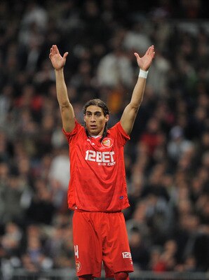 MADRID, SPAIN - FEBRUARY 02: Martin Caceres of Sevilla signals to a teammate during the Copa del Rey semi-final second leg match between Real Madrid and Sevilla at Estadio Santiago Bernabeu on February 2, 2011 in Madrid, Spain.  (Photo by Denis Doyle/Gett
