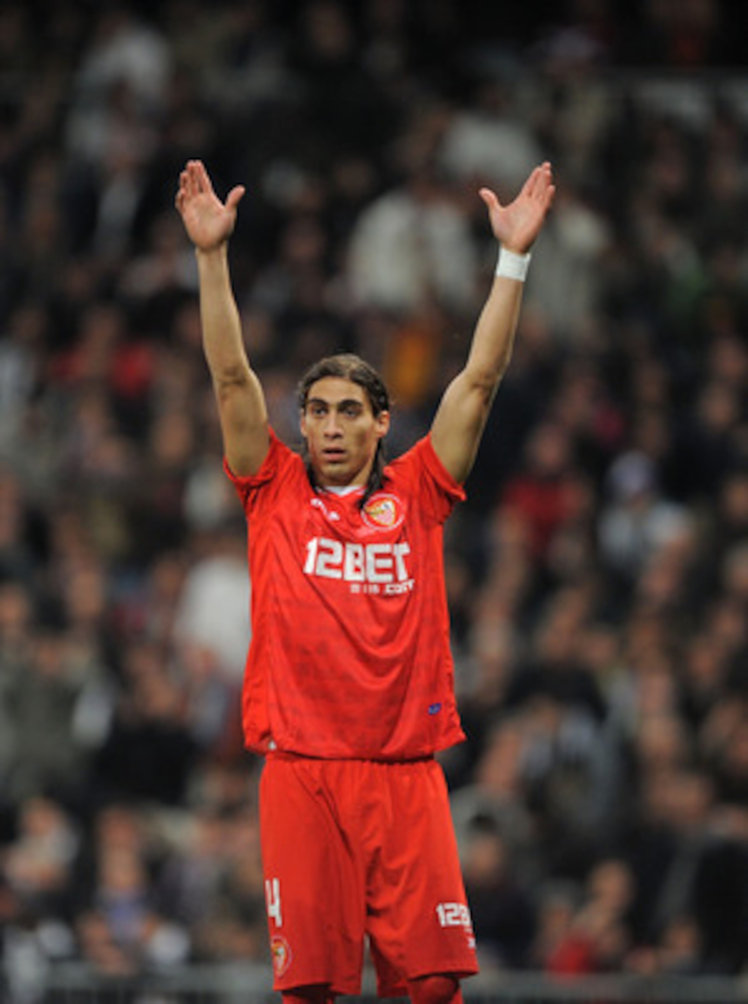MADRID, SPAIN - FEBRUARY 02: Martin Caceres of Sevilla signals to a teammate during the Copa del Rey semi-final second leg match between Real Madrid and Sevilla at Estadio Santiago Bernabeu on February 2, 2011 in Madrid, Spain.  (Photo by Denis Doyle/Gett