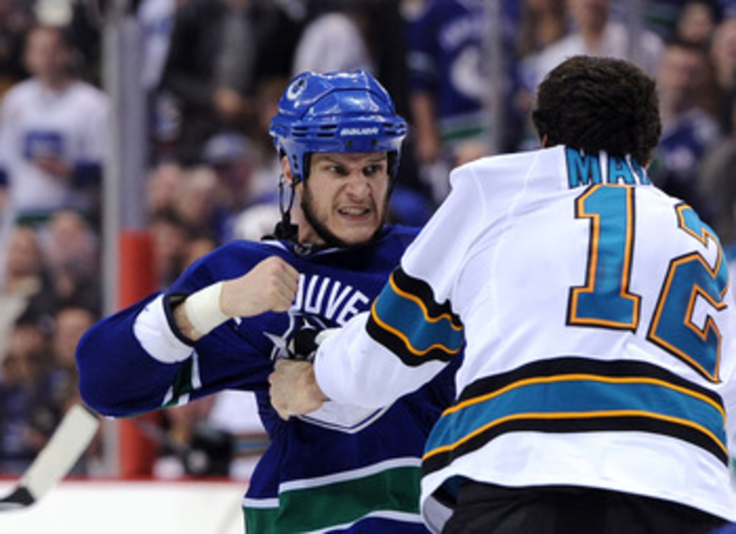 VANCOUVER, BC - MAY 18:  Kevin Bieksa #3 of the Vancouver Canucks prepares to throw a punch at Patrick Marleau #12 of the San Jose Sharks in the second period in Game Two of the Western Conference Finals during the 2011 Stanley Cup Playoffs at Rogers Aren