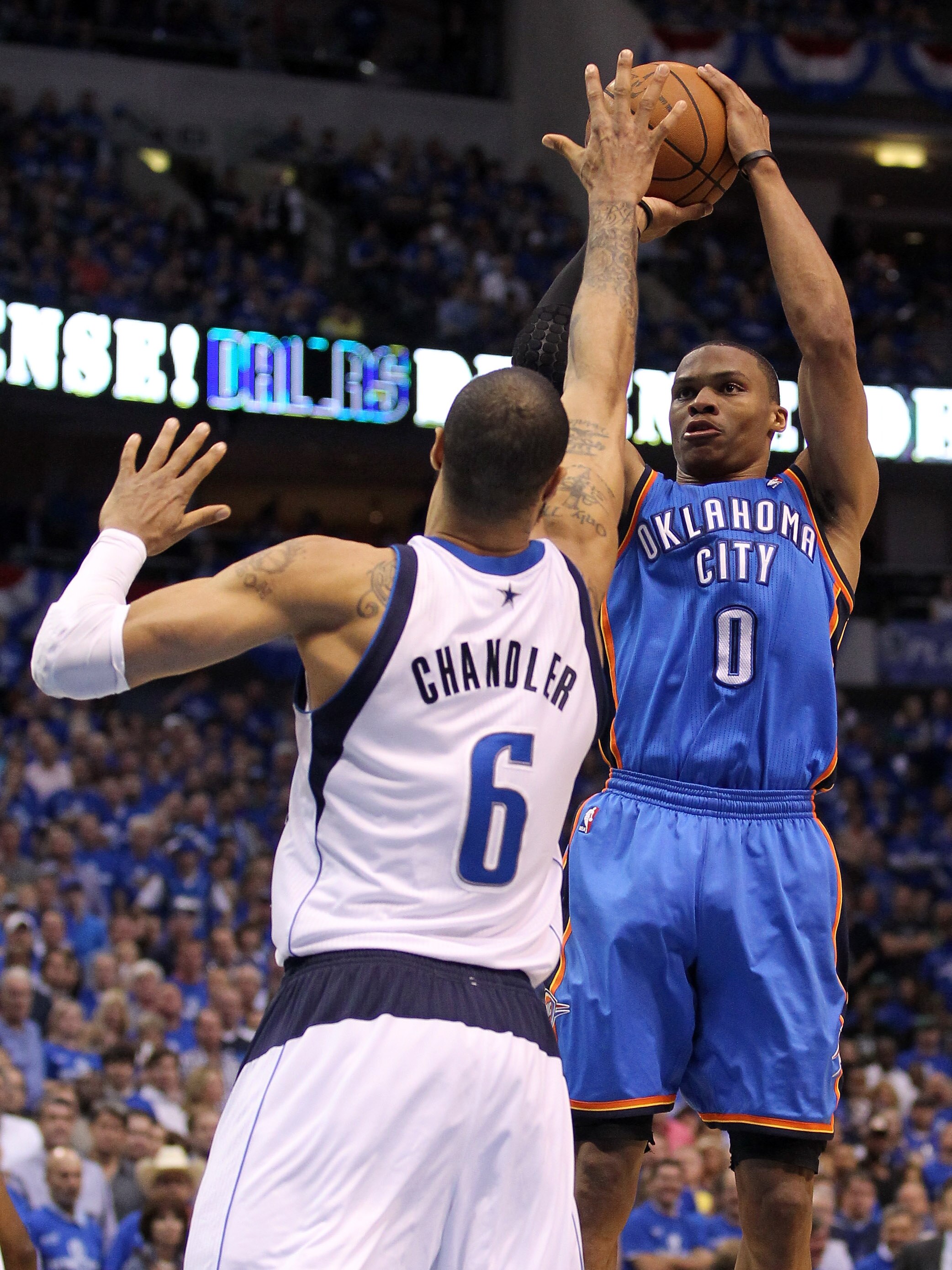 DALLAS, TX - MAY 25:  Russell Westbrook #0 of the Oklahoma City Thunder shoots over Tyson Chandler #6 of the Dallas Mavericks in the fourth quarter in Game Five of the Western Conference Finals during the 2011 NBA Playoffs at American Airlines Center on M