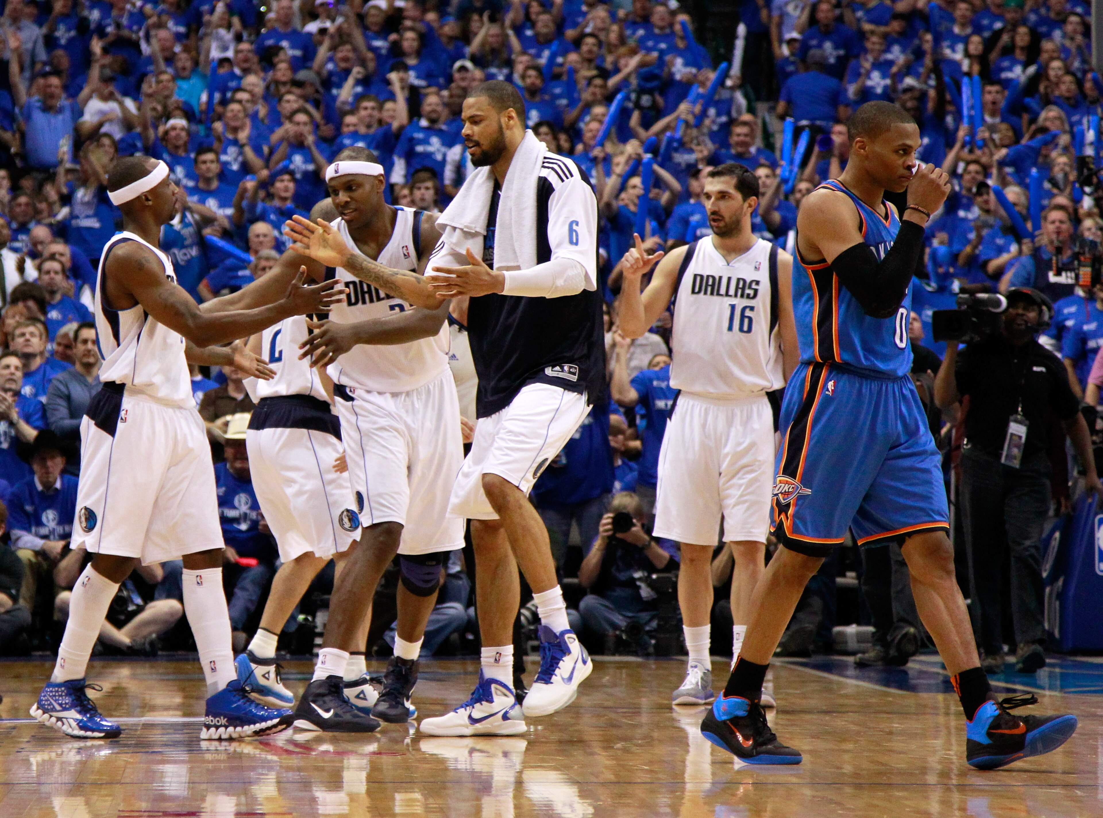 DALLAS, TX - MAY 25:  Jason Terry #31, Brendan Haywood #33 and Tyson Chandler #6 of the Dallas Mavericks react on the court in the third quarter as Russell Westbrook #0 of the Oklahoma City Thunder walks by in Game Five of the Western Conference Finals du