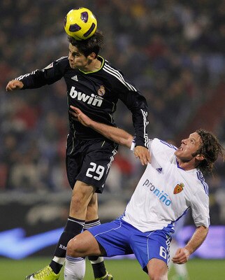 ZARAGOZA, SPAIN - DECEMBER 12: Alvaro Morataof Real Madrid jumps for a high ball with Maurizio Lanzaro of Zaragoza during the La Liga match between Real Zaragoza and Real Madrid at La Romareda stadium on December 12, 2010 in Zaragoza, Spain. (Photo by Ang
