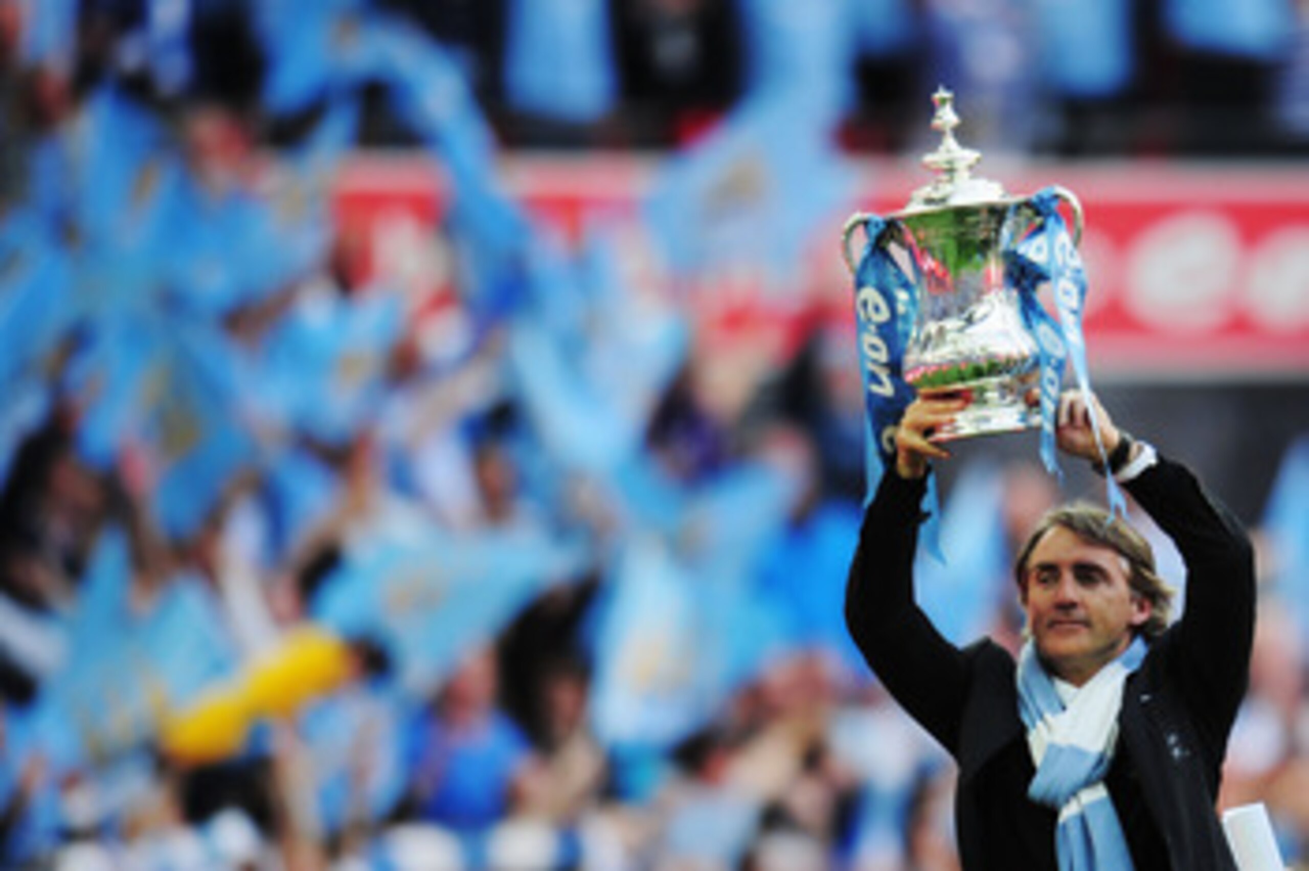 LONDON, ENGLAND - MAY 14: Roberto Mancini lifts the trophy after his Manchester City team wins the FA Cup sponsored by E.ON Final match between Manchester City and Stoke City at Wembley Stadium on May 14, 2011 in London, England. (Photo by Shaun Botteri LONDON, ENGLAND - MAY 14: Roberto Mancini lifts the trophy after his Manchester City team wins the FA Cup sponsored by E.ON Final match between Manchester City and Stoke City at Wembley Stadium on May 14, 2011 in London, England. (Photo by Shaun Botteri