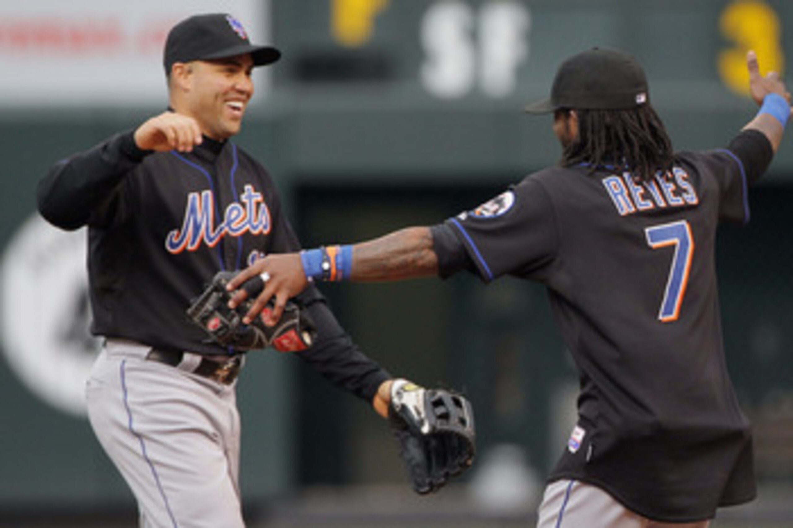 DENVER, CO - MAY 12:  Carlos Beltran #15 and Jose Reyes #7 of the New York Mets celebrate their 9-5 victory over the Colorado Rockies at Coors Field on May 12, 2011 in Denver, Colorado.  (Photo by Doug Pensinger/Getty Images)