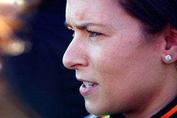 DAYTONA BEACH, FL - FEBRUARY 18:  Danica Patrick, driver of the #7 GoDaddy.com Chevrolet, looks on in the garage area after driving during qualifying for the NASCAR Nationwide Series DRIVE4COPD 300 at Daytona International Speedway on February 18, 2011 in