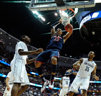 ANAHEIM, CA - MARCH 26:  Derrick Williams #23 of the Arizona Wildcats dunks the ball against Roscoe Smith #22 and Charles Okwandu #35 of the Connecticut Huskies during the west regional final of the 2011 NCAA men's basketball tournament at the Honda Cente