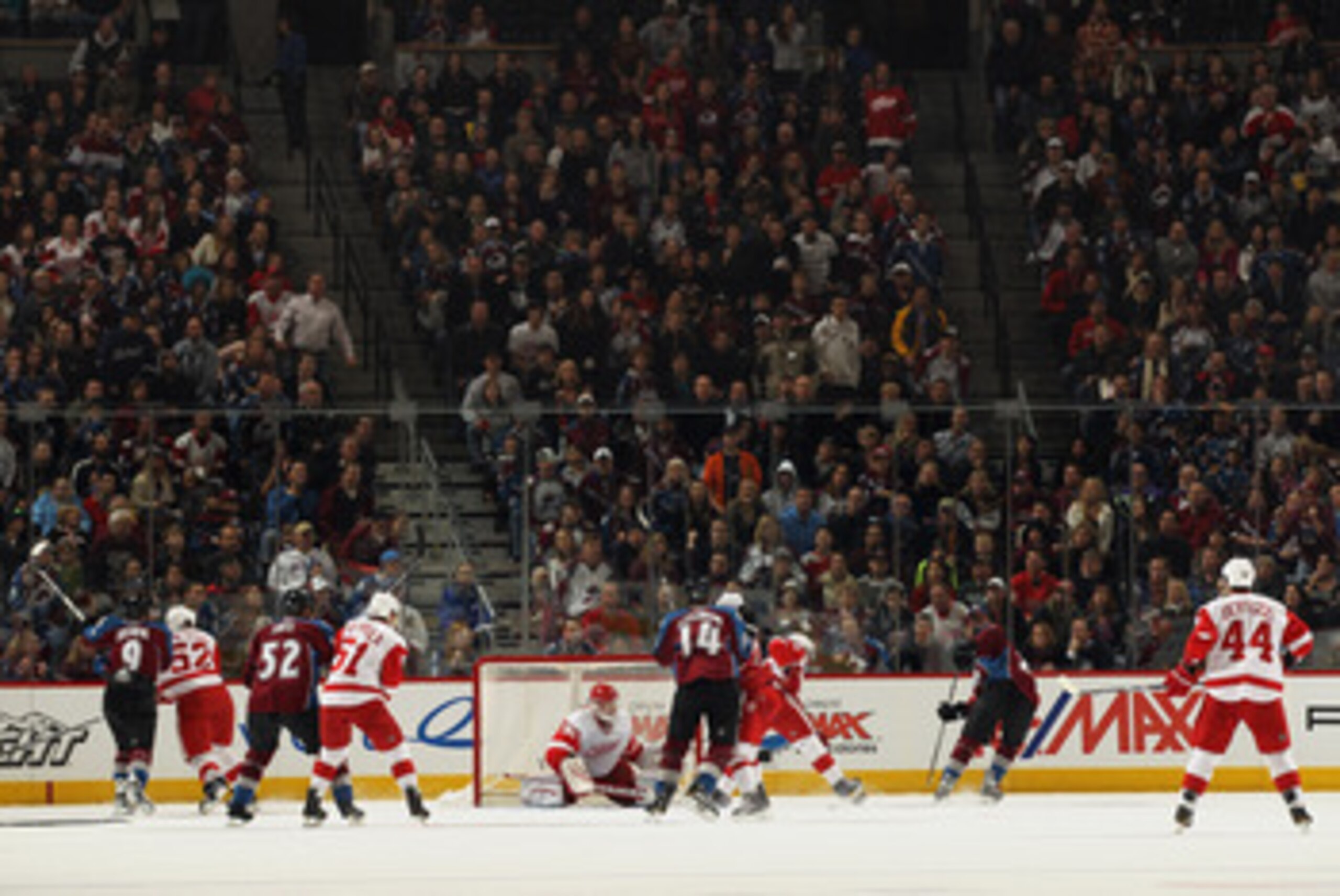DENVER - DECEMBER 27:  Goalie Chris Osgood #30 of the Detroit Red Wings defends the goal as Paul Stastny #26 of the Colorado Avalanche takes a shot at the Pepsi Center on December 27, 2010 in Denver, Colorado. Osgood earned his 400th win and collected 46