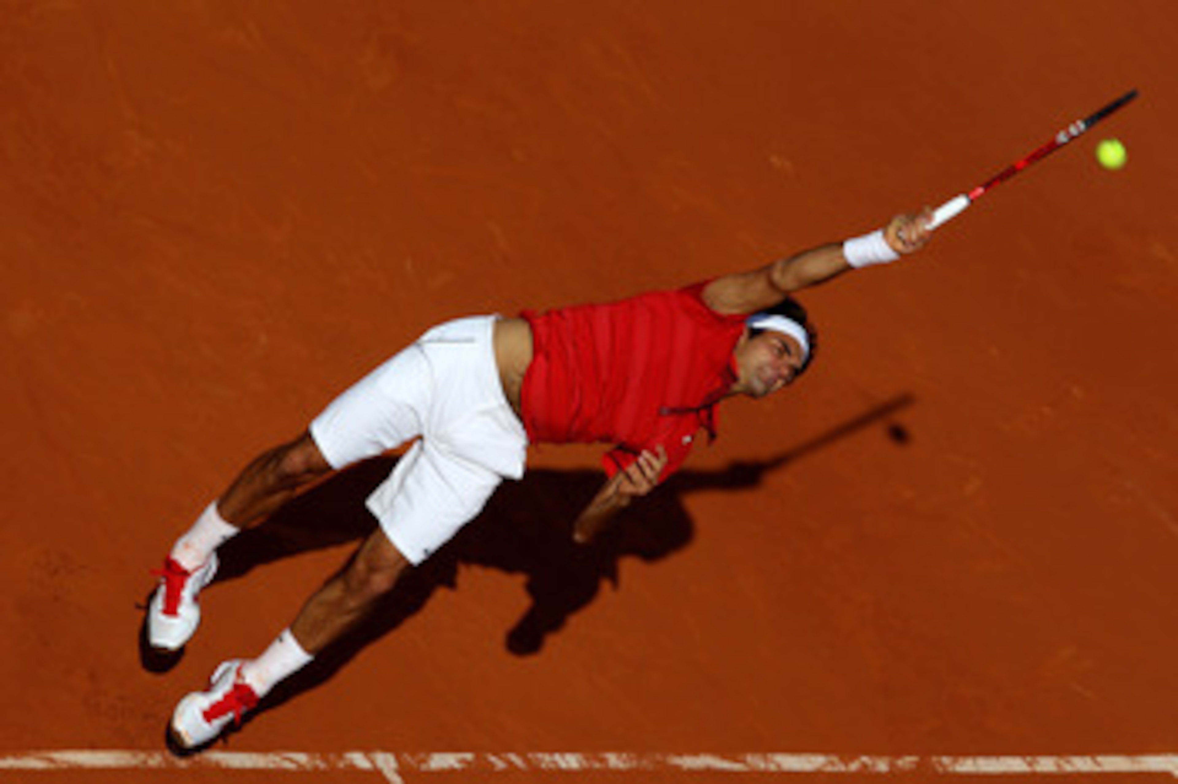 PARIS, FRANCE - MAY 31:  Roger Federer of Switzerland serves during the men's singles quarterfinal match between Gael Monfils of France and Roger Federer of Switzerland on day ten of the French Open at Roland Garros on May 31, 2011 in Paris, France.  (Pho