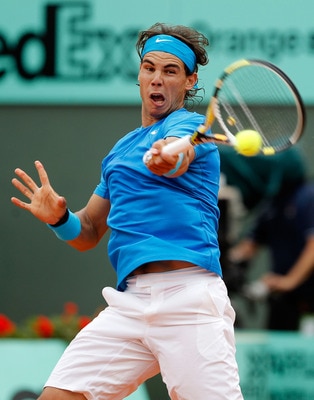 PARIS, FRANCE - MAY 30:  Rafael Nadal of Spain hits a forehand during the men's singles round four match between Rafael Nadal of Spain and Ivan Lubicic of Croatia on day nine of the French Open at Roland Garros on May 30, 2011 in Paris, France.  (Photo by