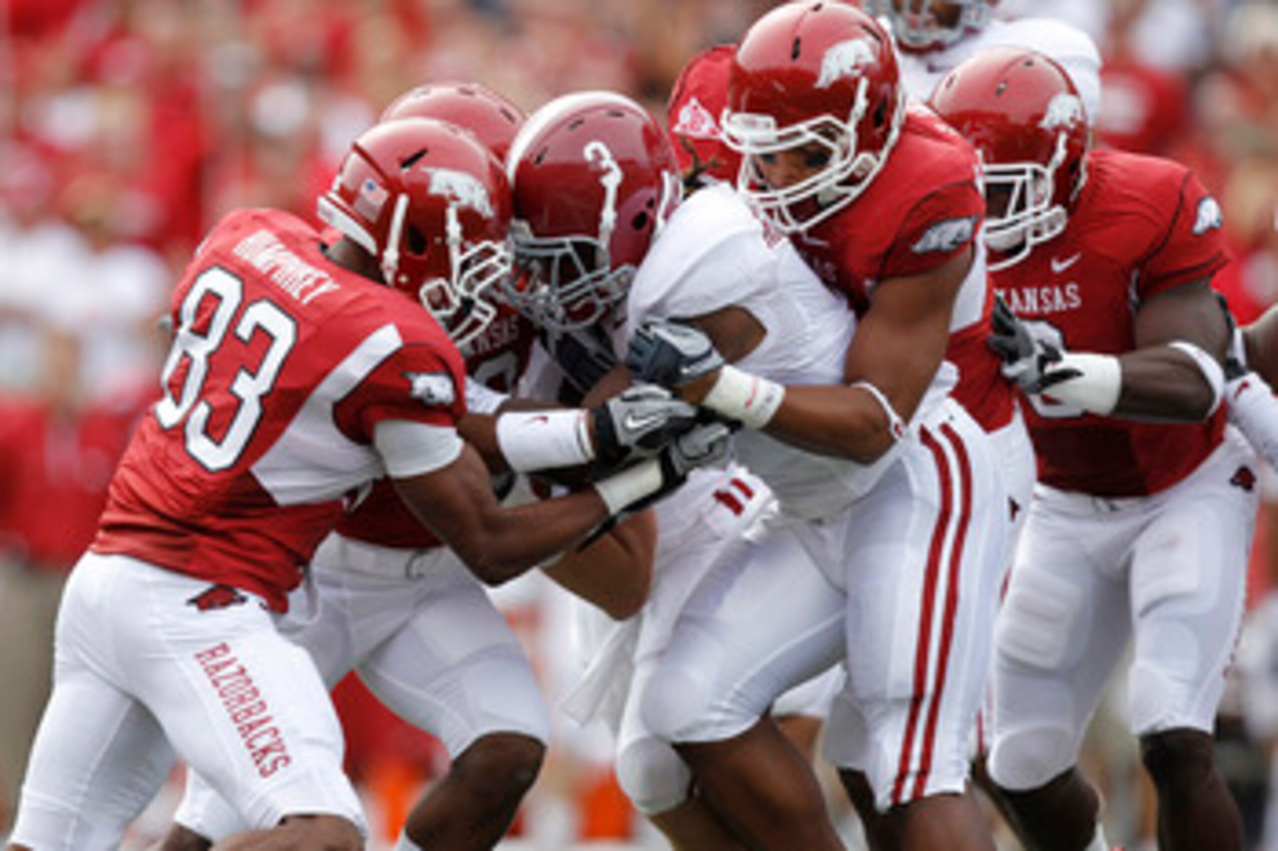 FAYETTEVILLE - SEPTEMBER 25: Trent Richardson #3 of the Alabama Crimson Tide gets tackled by a group of Arkansas Razorbacks defenders during the first half at Donald W. Reynolds Razorback Stadium on September 25, 2010 in Fayetteville, Arkansas. (Photo by 
